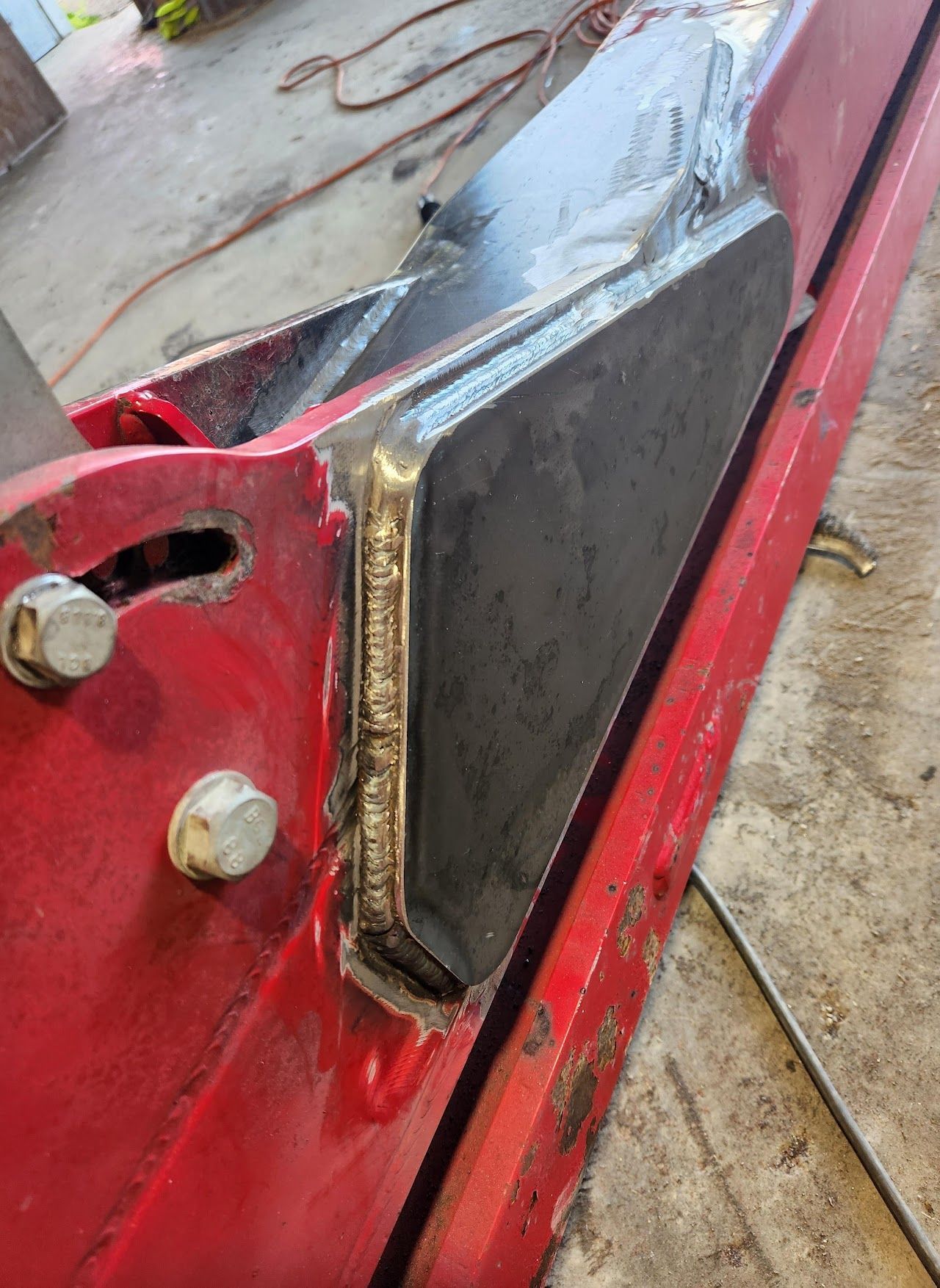 A close up of a piece of metal that is being repaired.