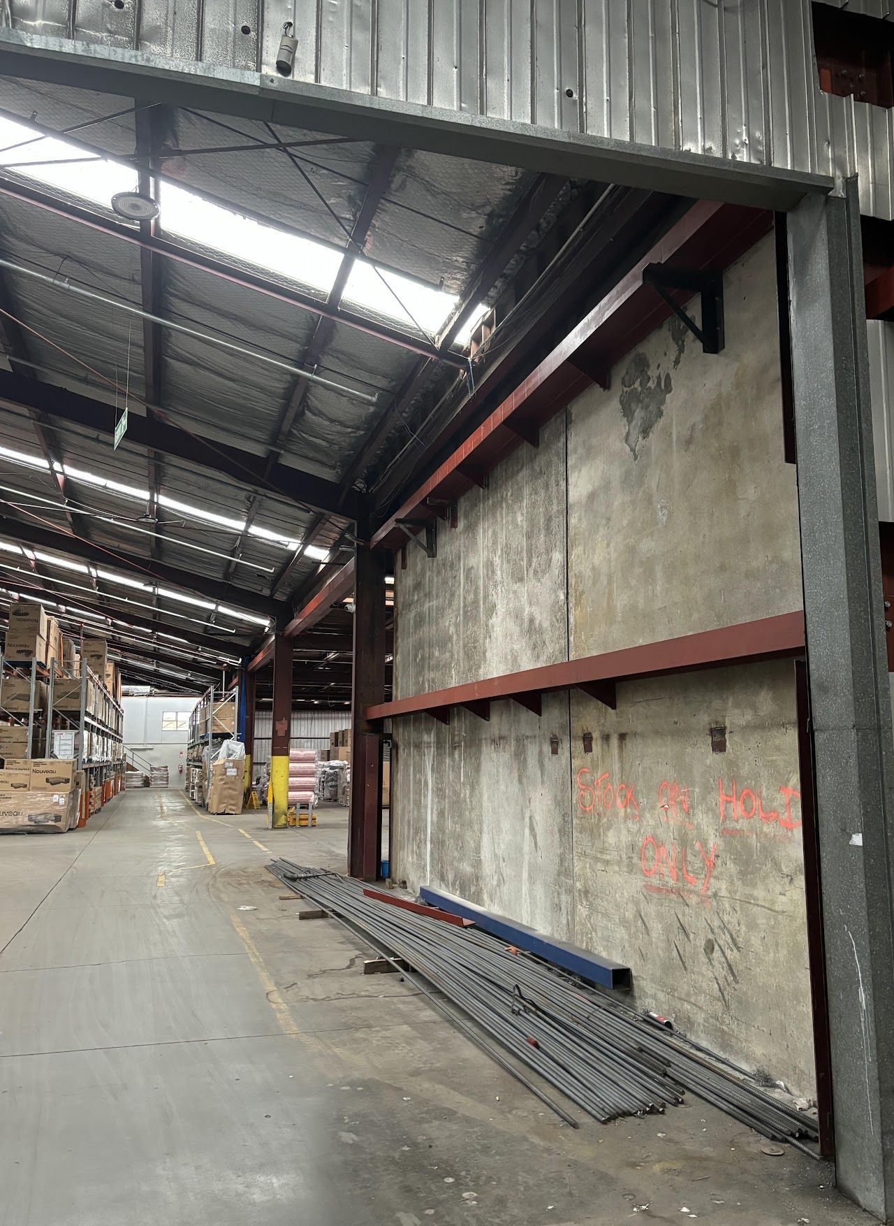 A large warehouse with a lot of boxes on the floor.