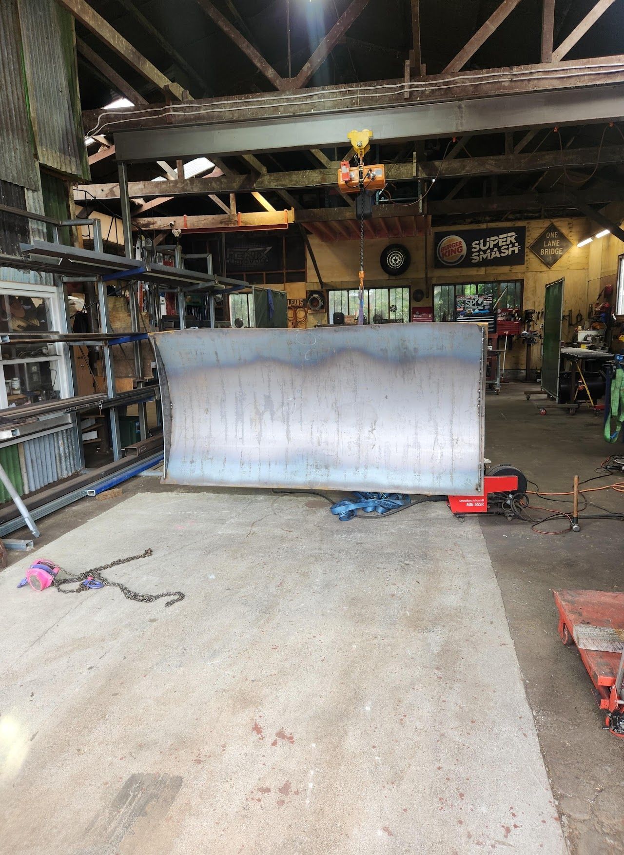 A large piece of metal is sitting in the middle of a garage.