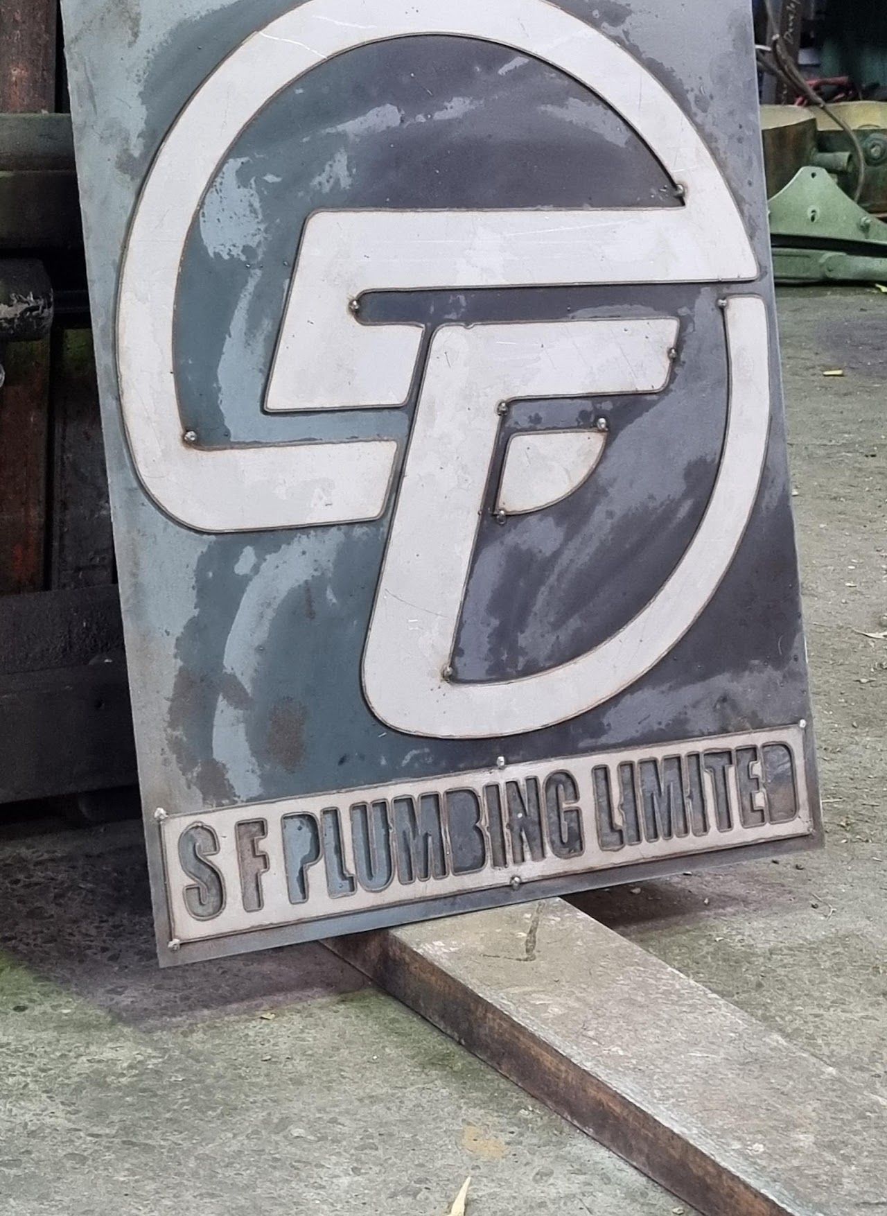 A sign that says ' sf plumbing limited ' on it.