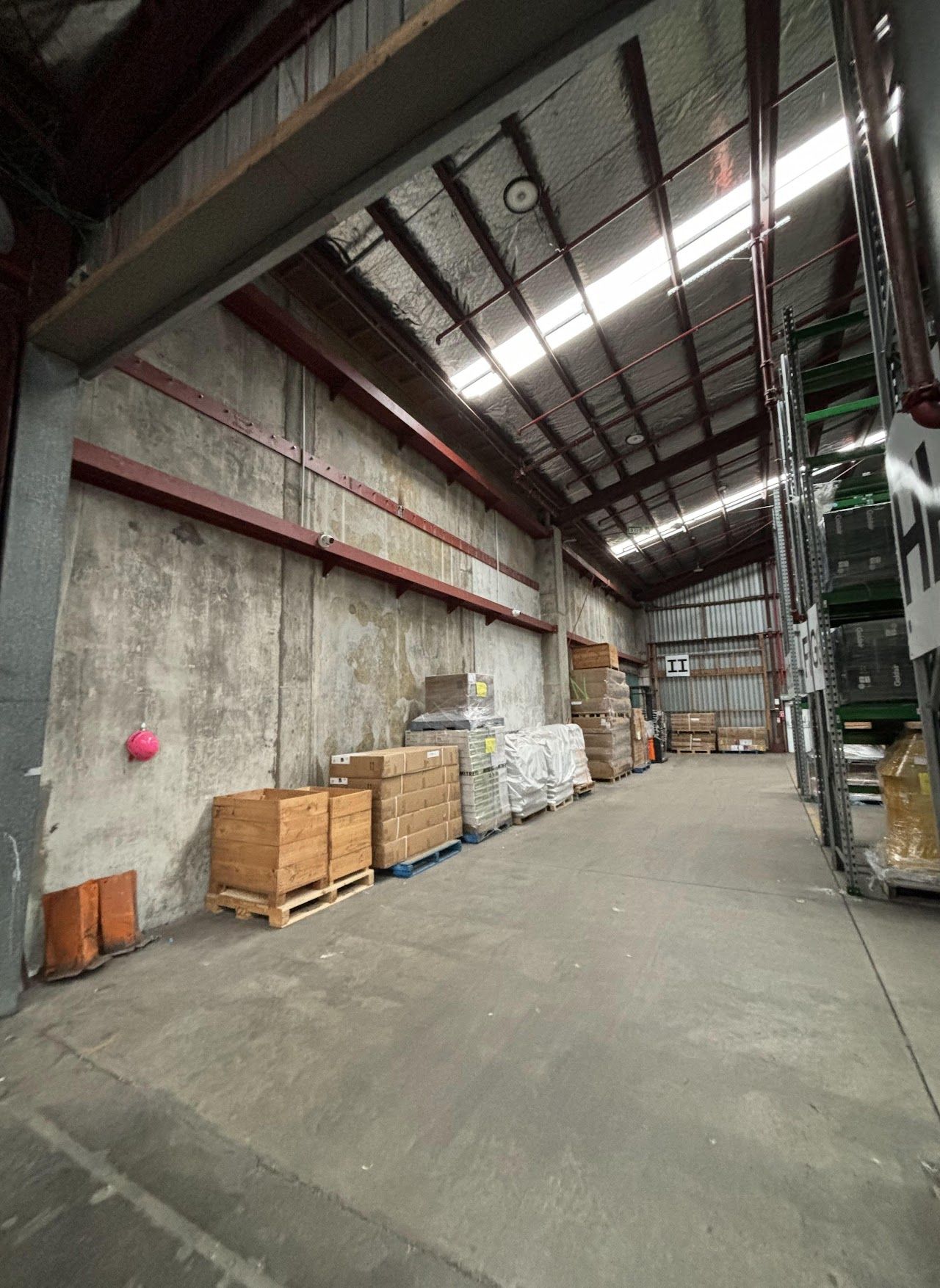 A large warehouse filled with lots of boxes and pallets.