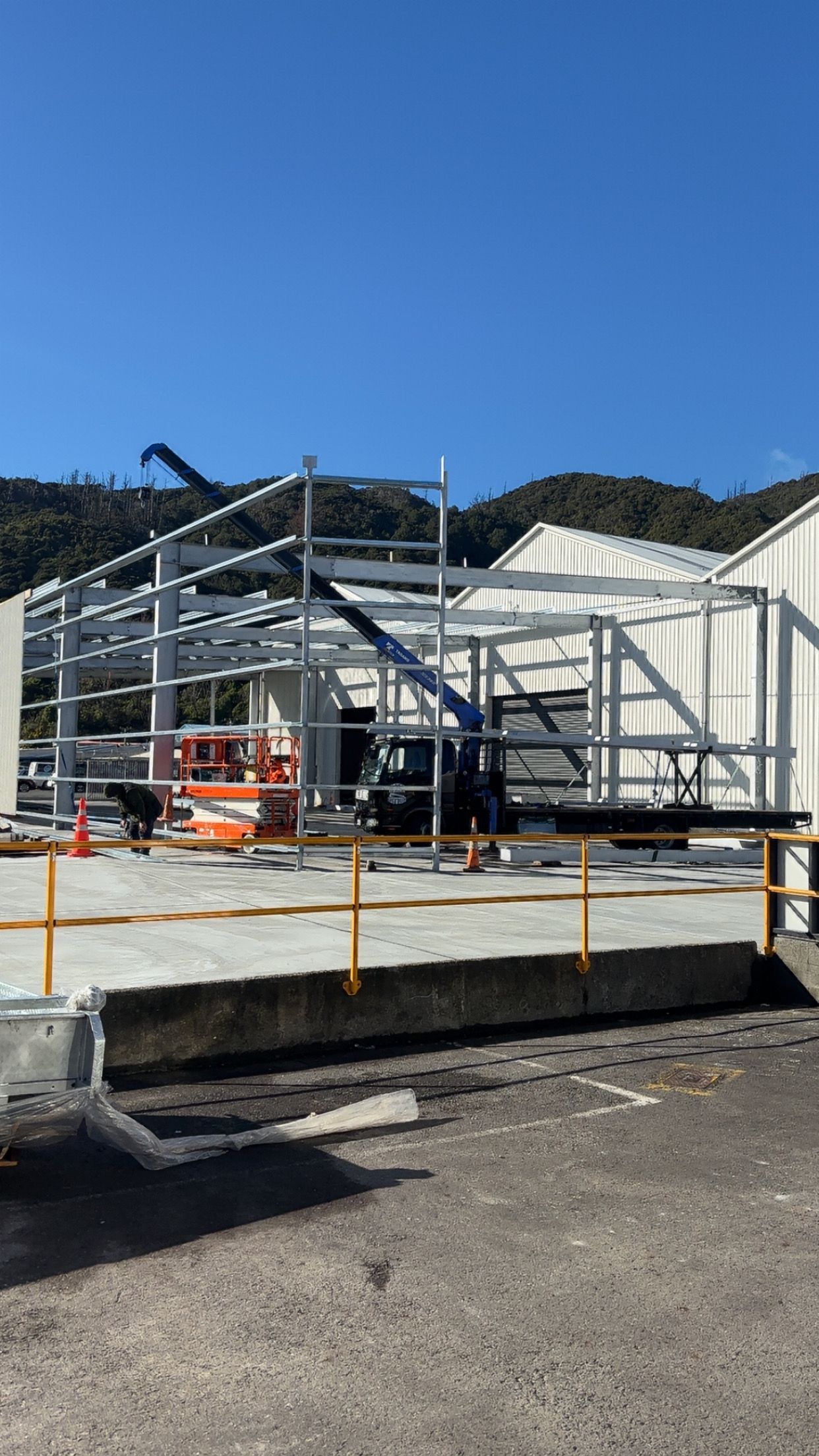 A metal frame is sitting on top of a wooden table in a workshop.