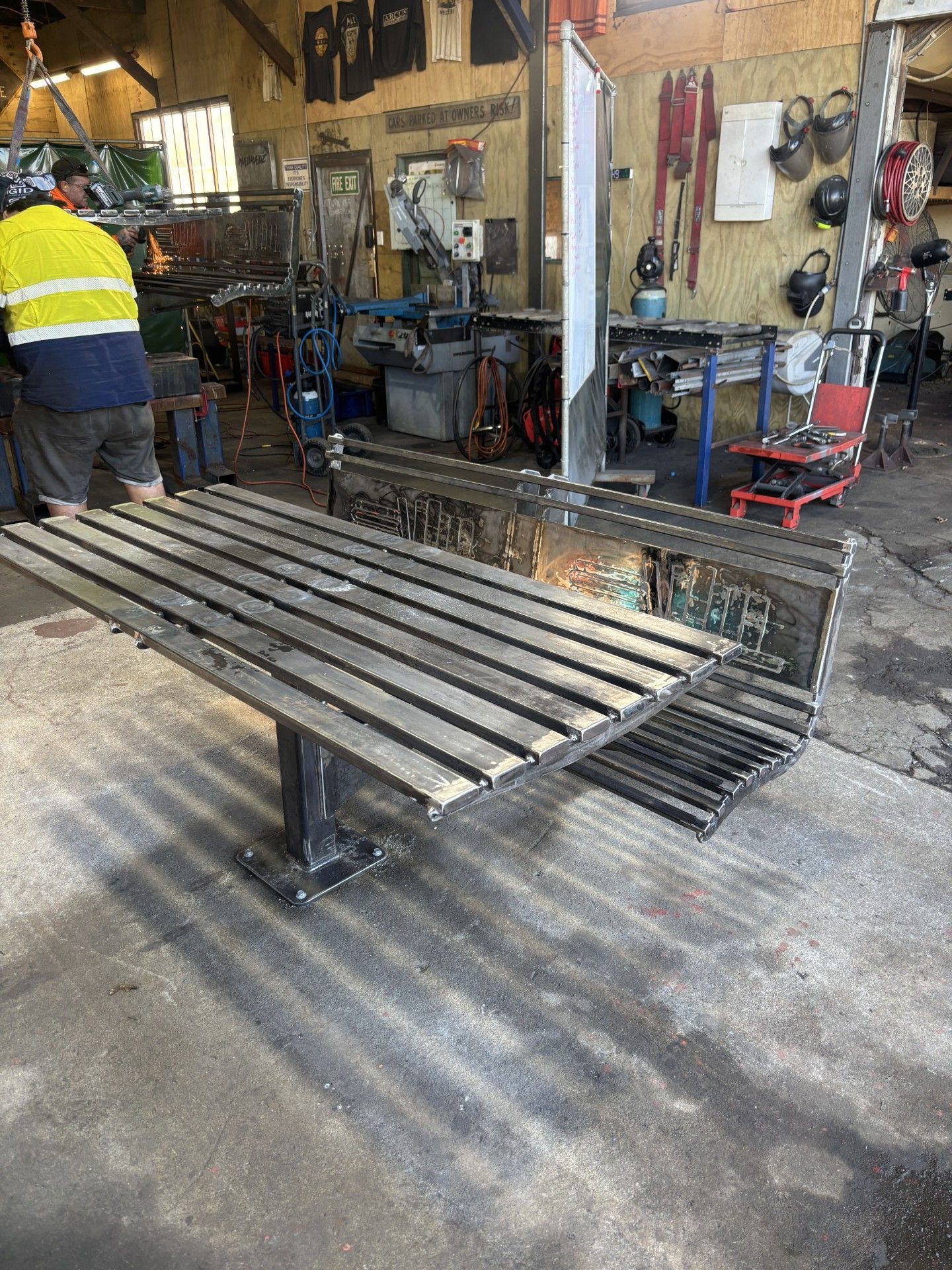 A man is working on a bench in a workshop.