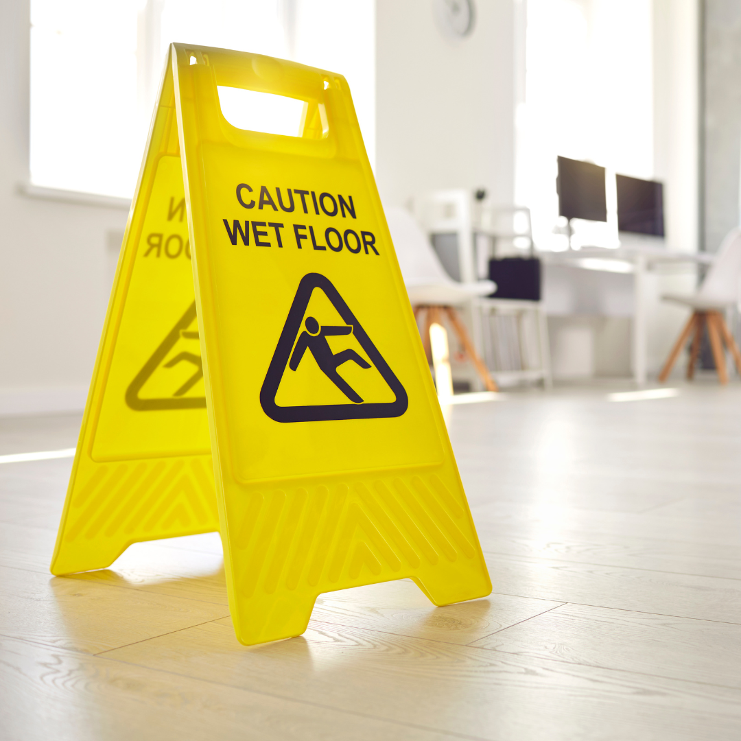 A yellow sign that says caution wet floor on it