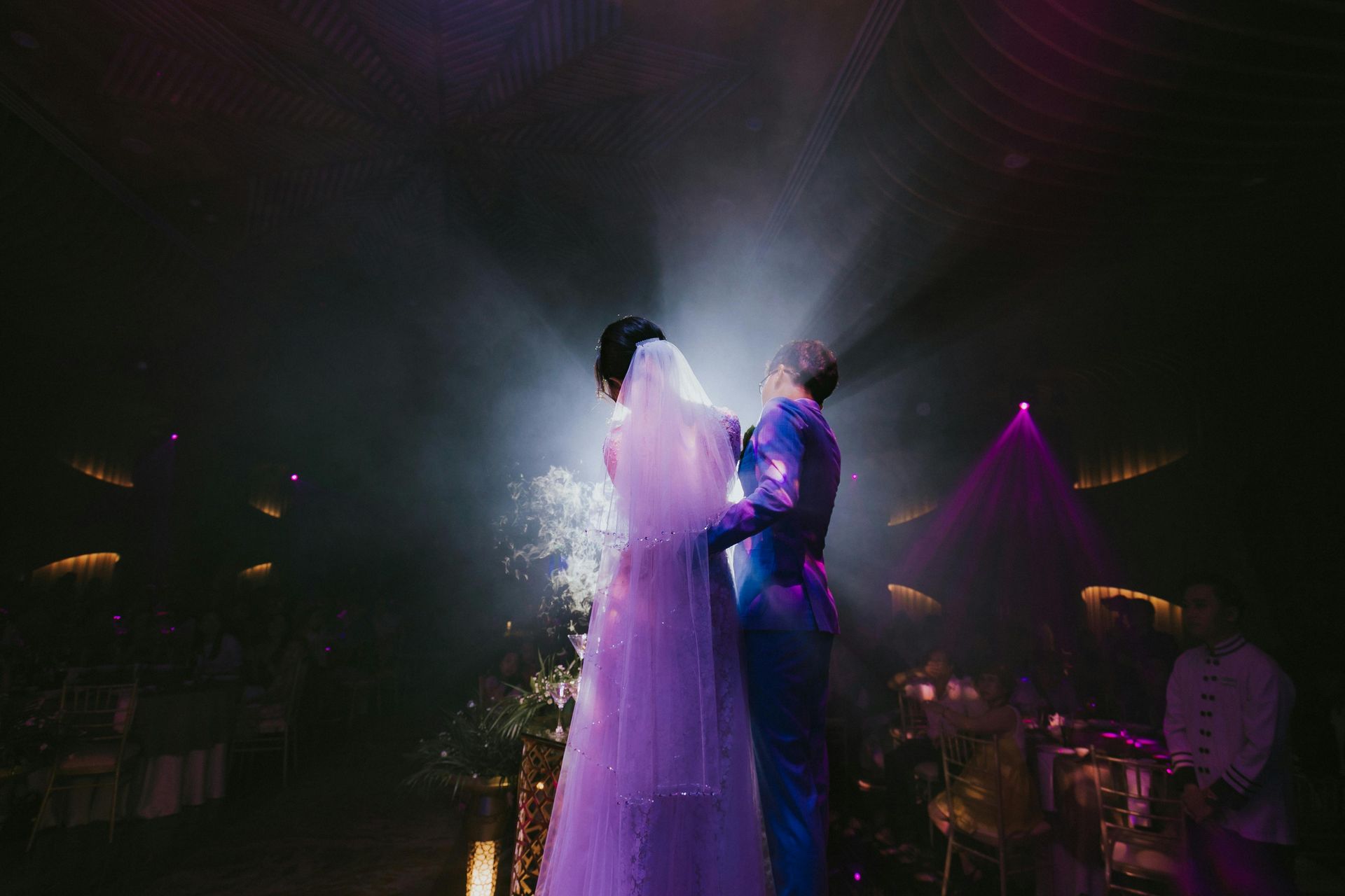 Wedding Dj Service from Musica entertainment. Couple in wedding attire dances under dramatic spotlights.