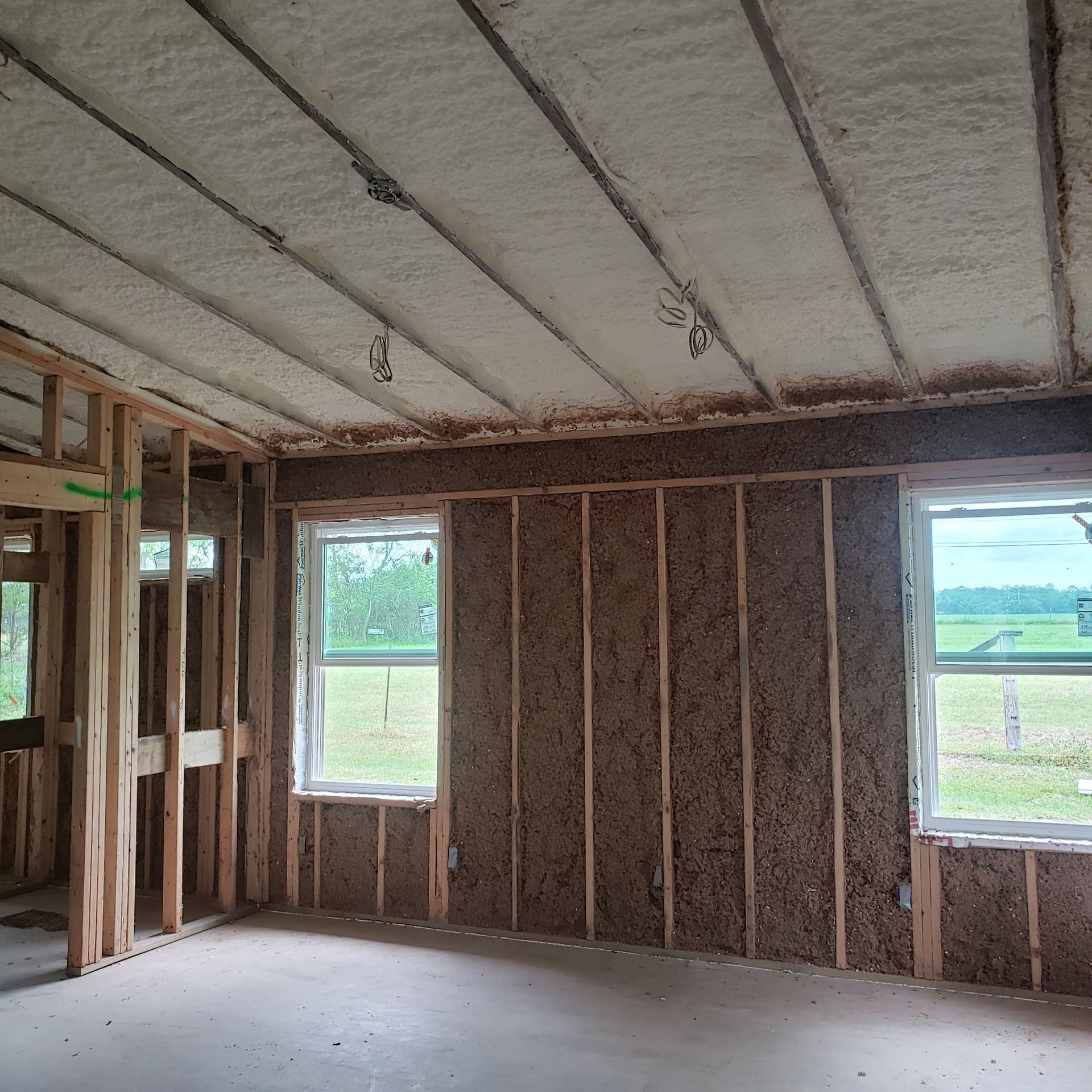 A ceiling with wooden beams and a scaffolding in the background