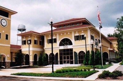 A large yellow building with a water tower on top of it