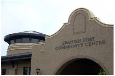 The spanish fort community center is a brick building with a dome on top of it.