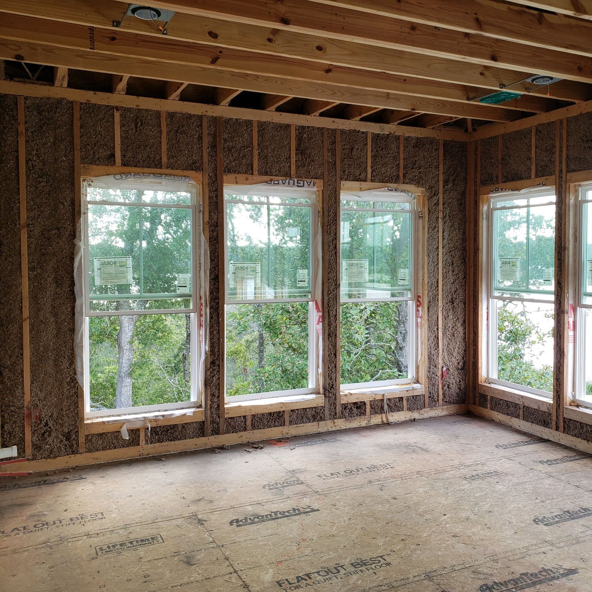 An empty room with lots of windows and a ceiling