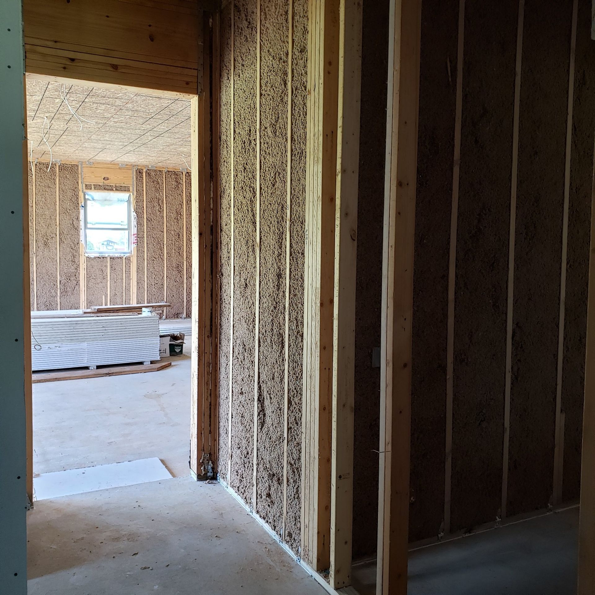A room with wooden walls and a window in it