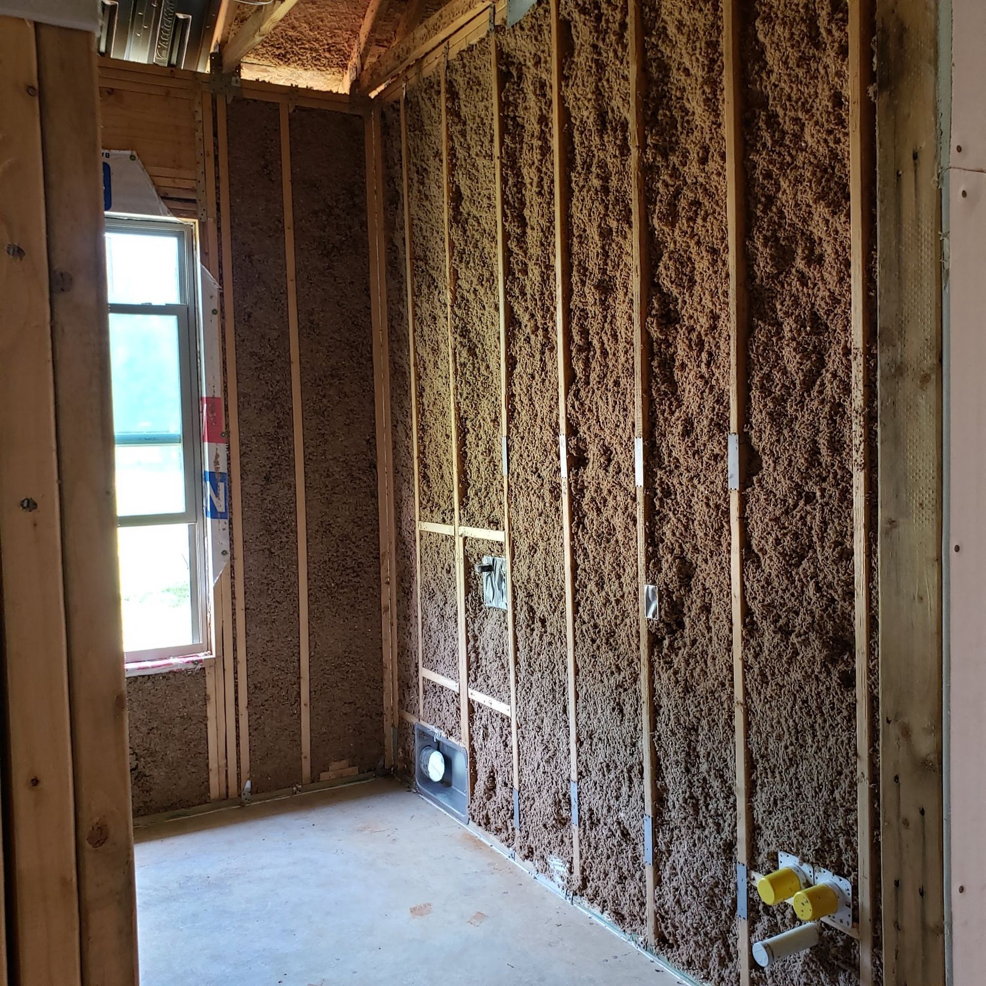 A room with wooden walls and a window