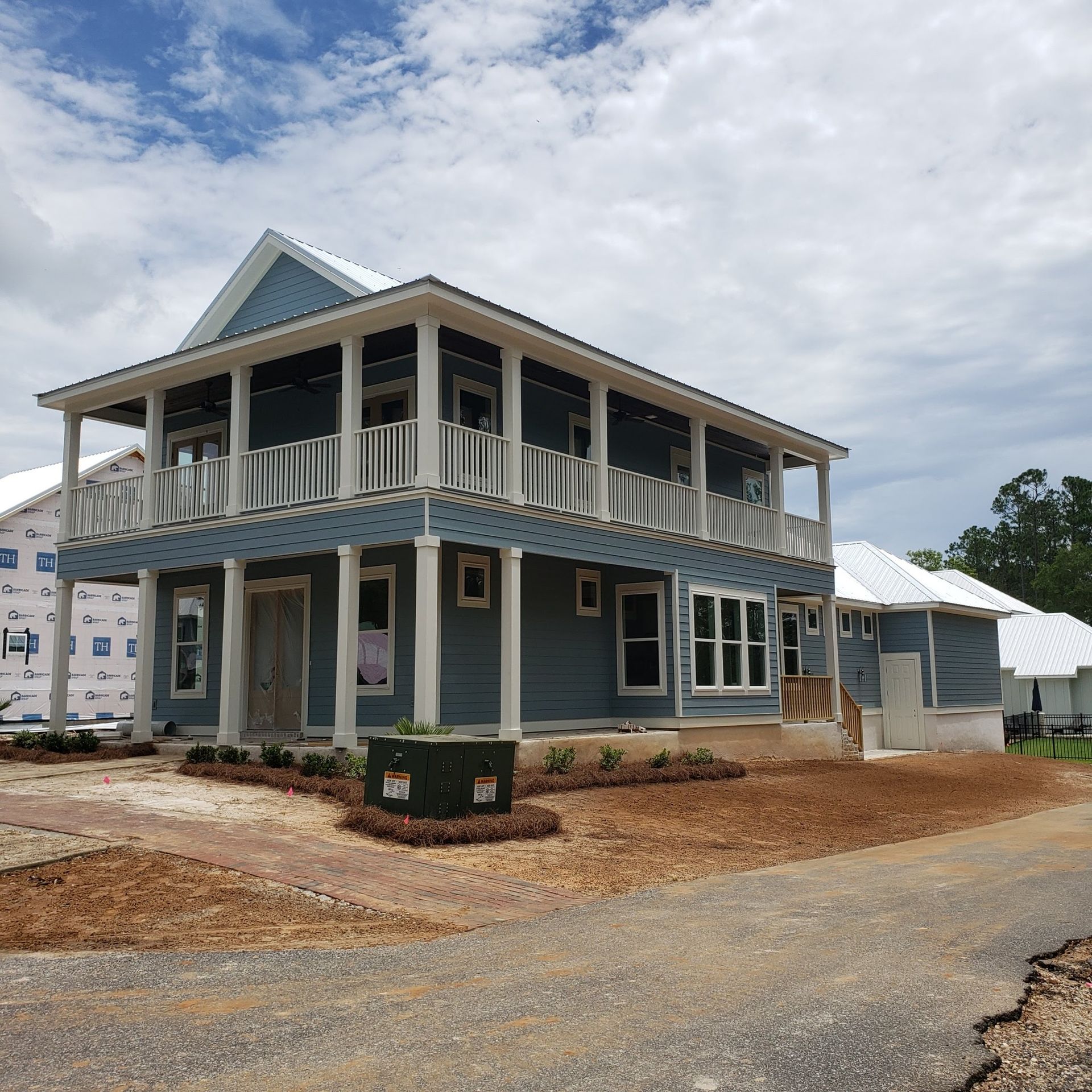 A large house with a lot of windows is being built