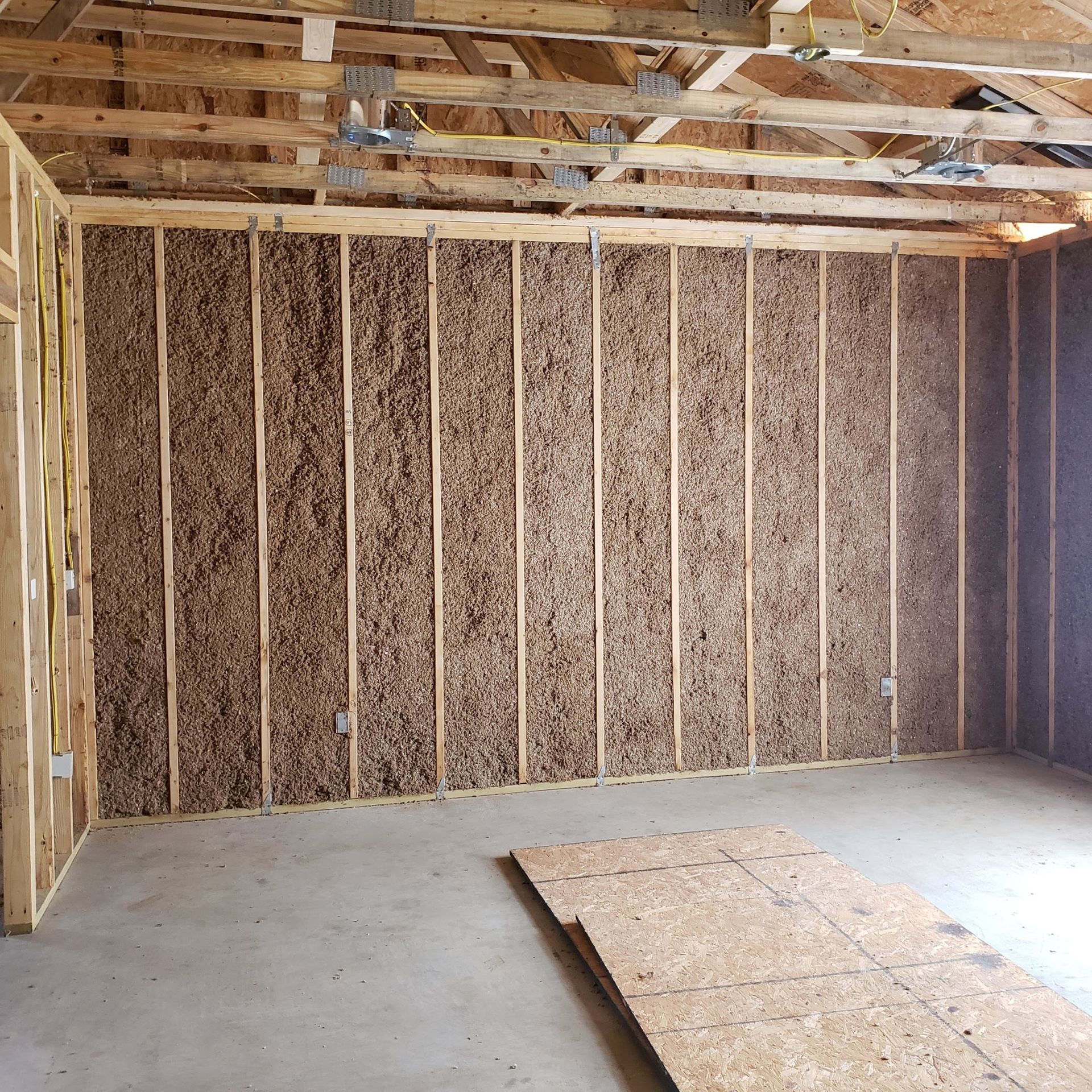 An empty room with a wooden ceiling and a wooden wall.