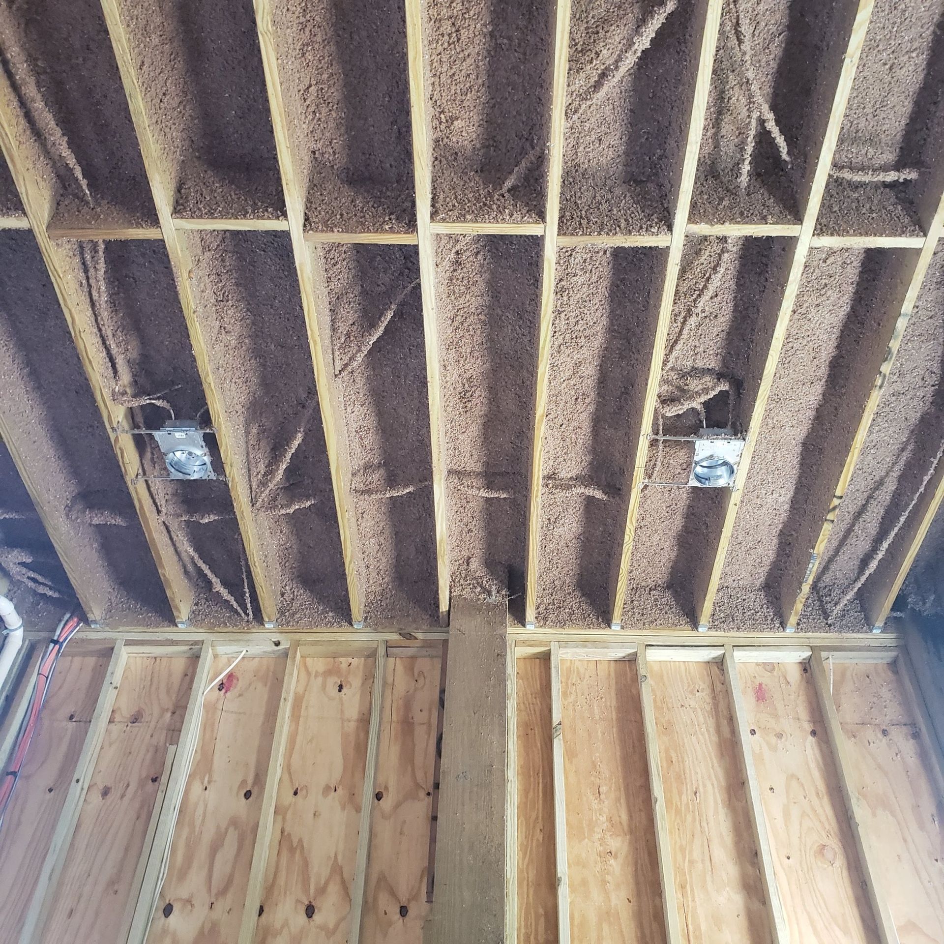 A ceiling with a lot of electrical wires coming out of it