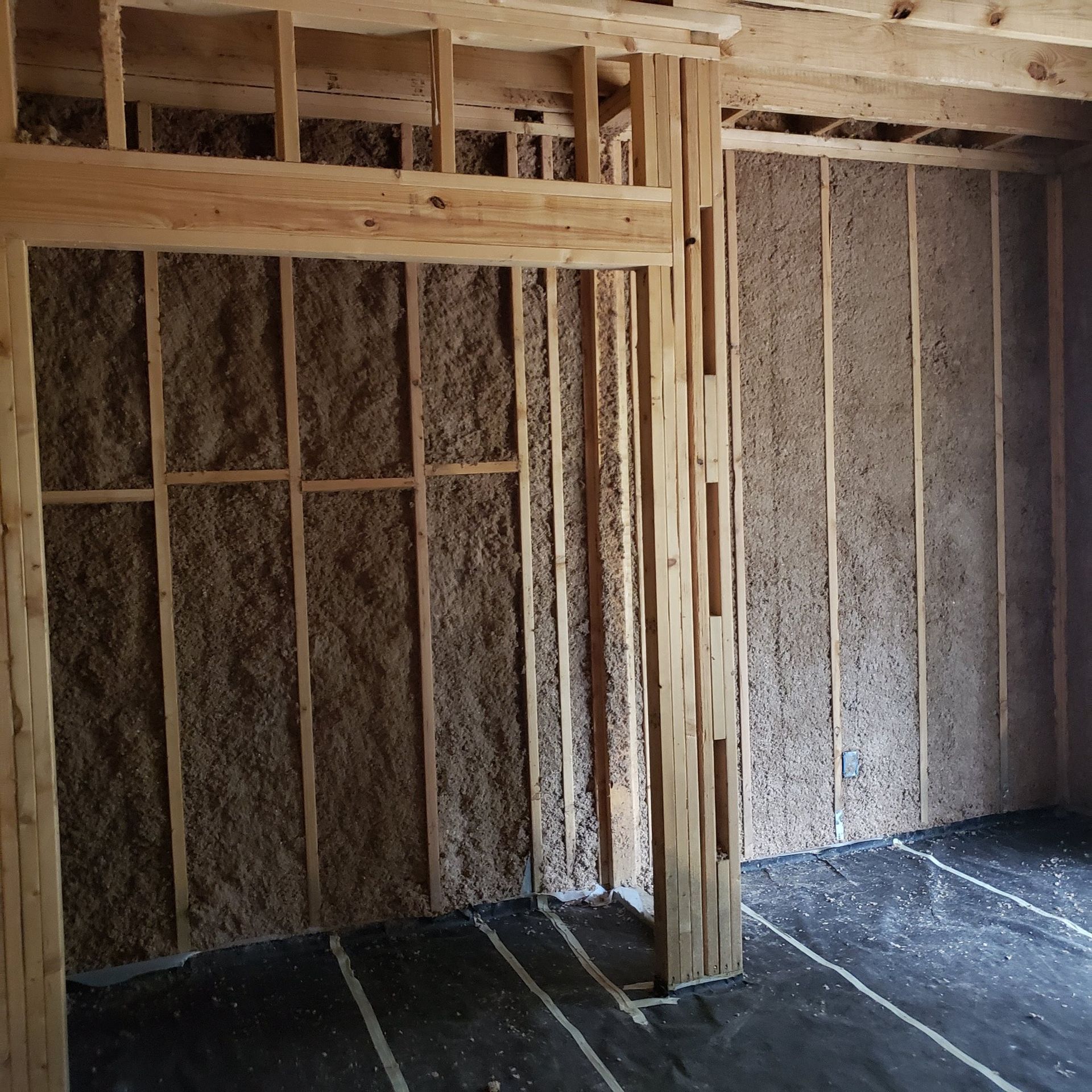 A room with wooden walls and a black floor