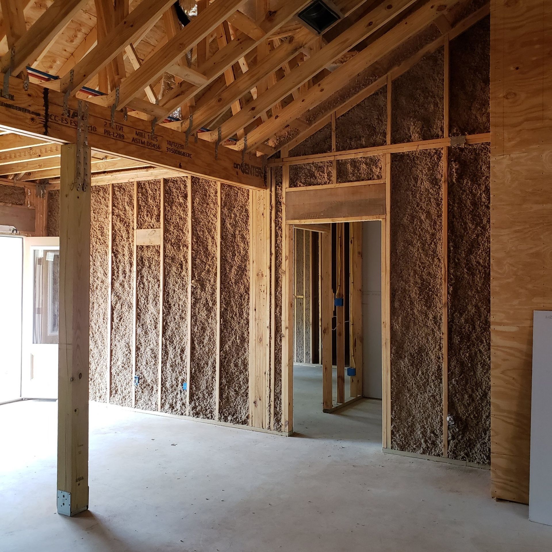 An empty room with wooden walls and a door