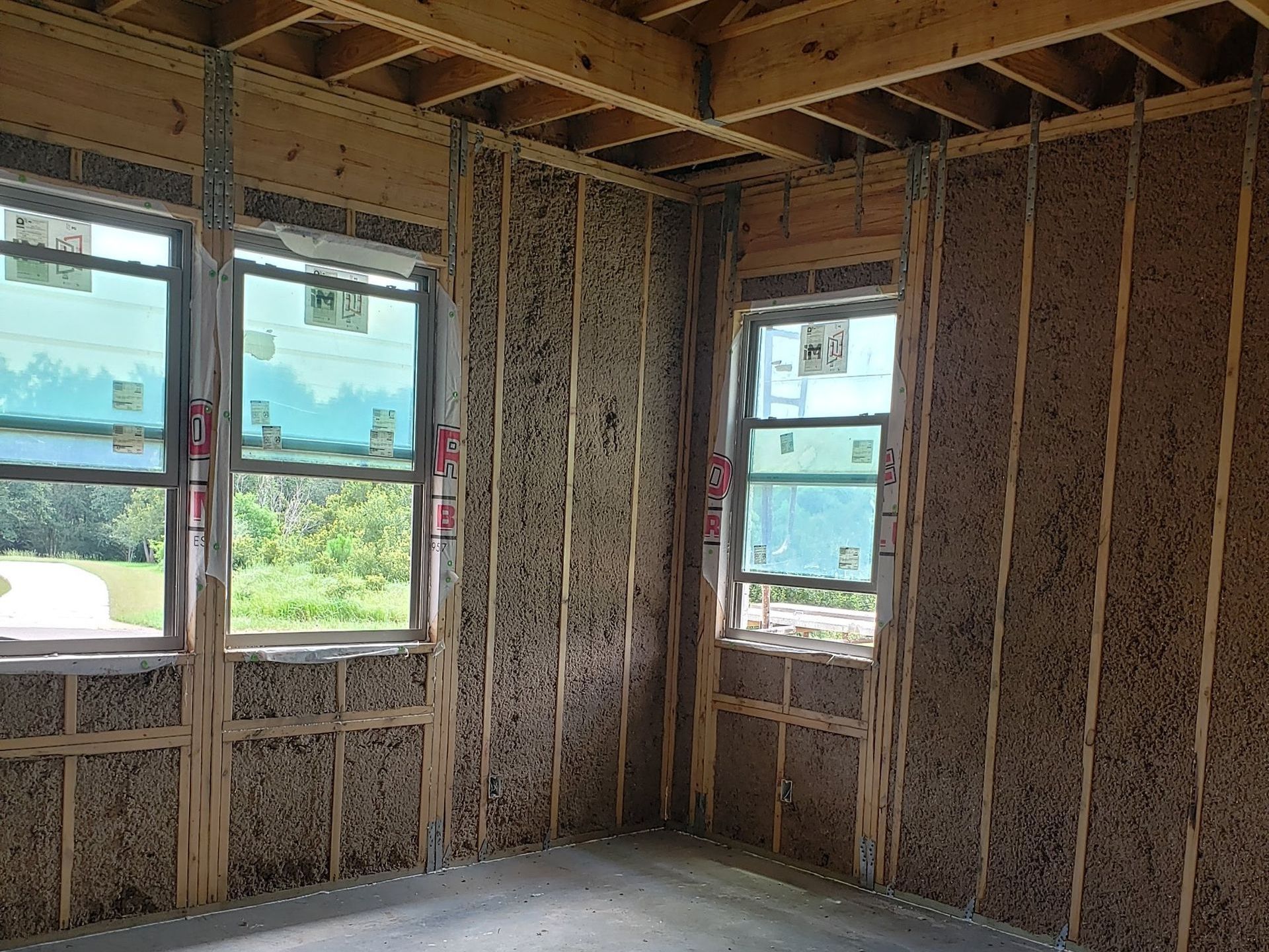A room with a lot of windows and wooden walls