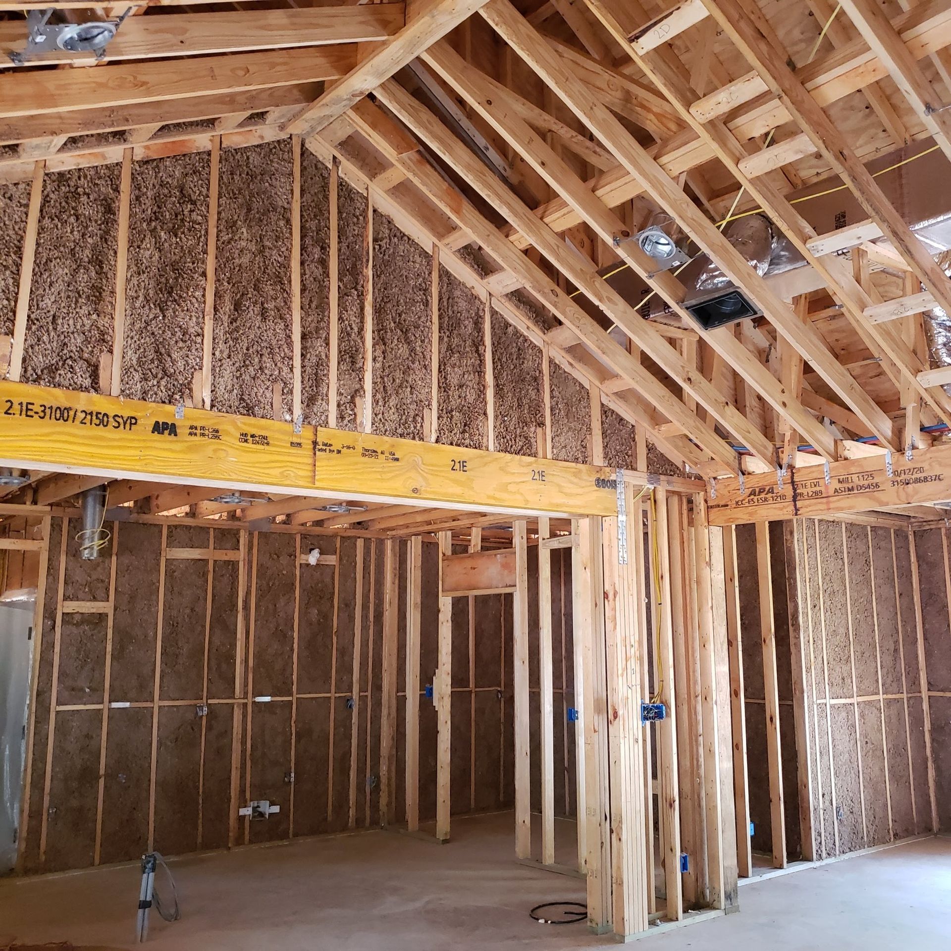 The inside of a house under construction with a yellow beam that says ' a ' on it