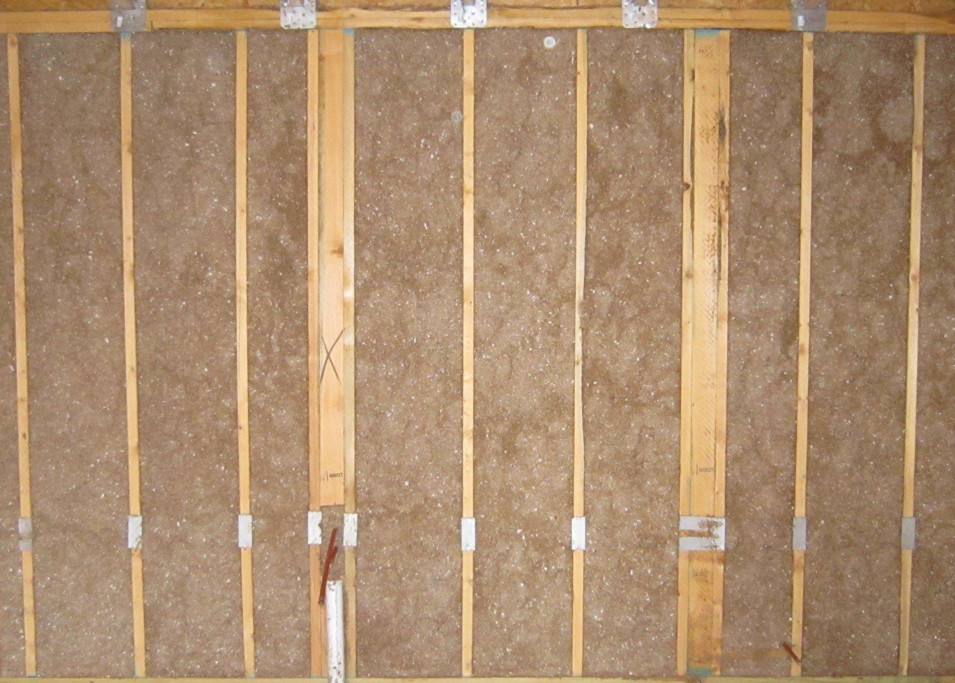 A wall with a lot of wooden beams on it