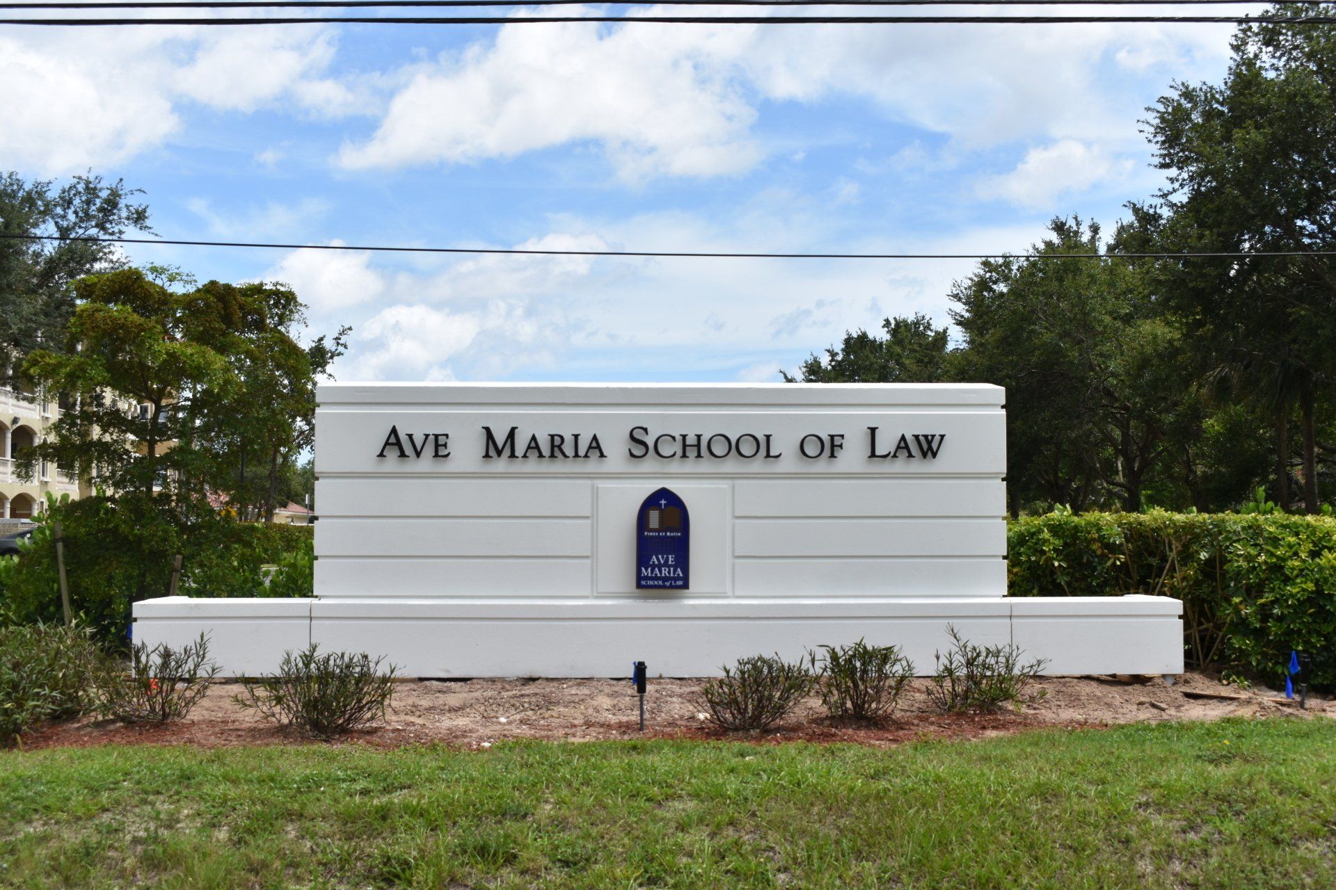 A large white sign for the ave maria school of law