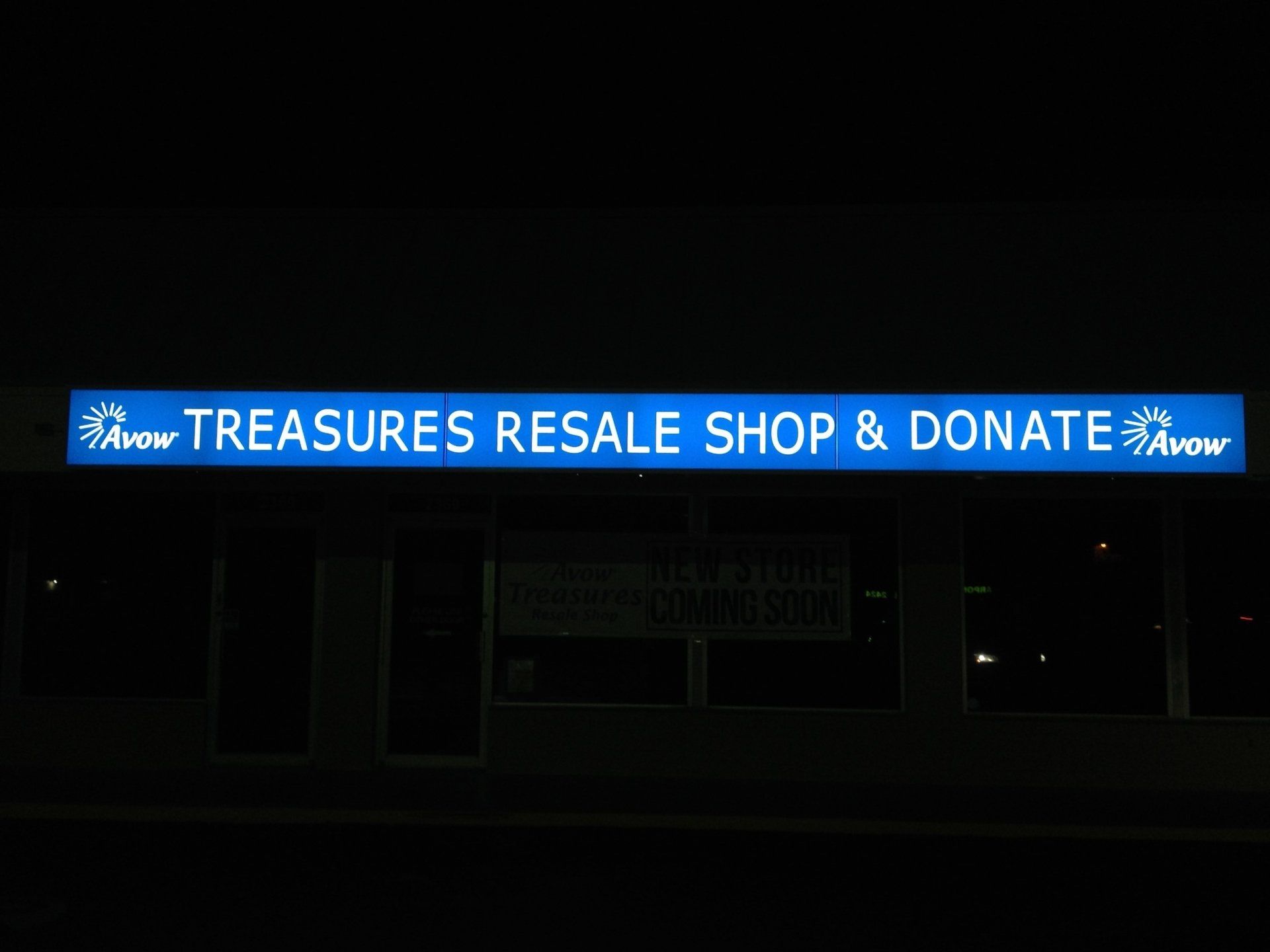 A blue sign that says treasures resale shop & donate