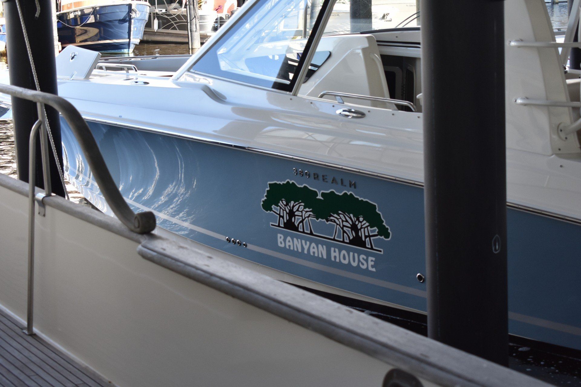 A boat with a sticker on the side that says banyan house