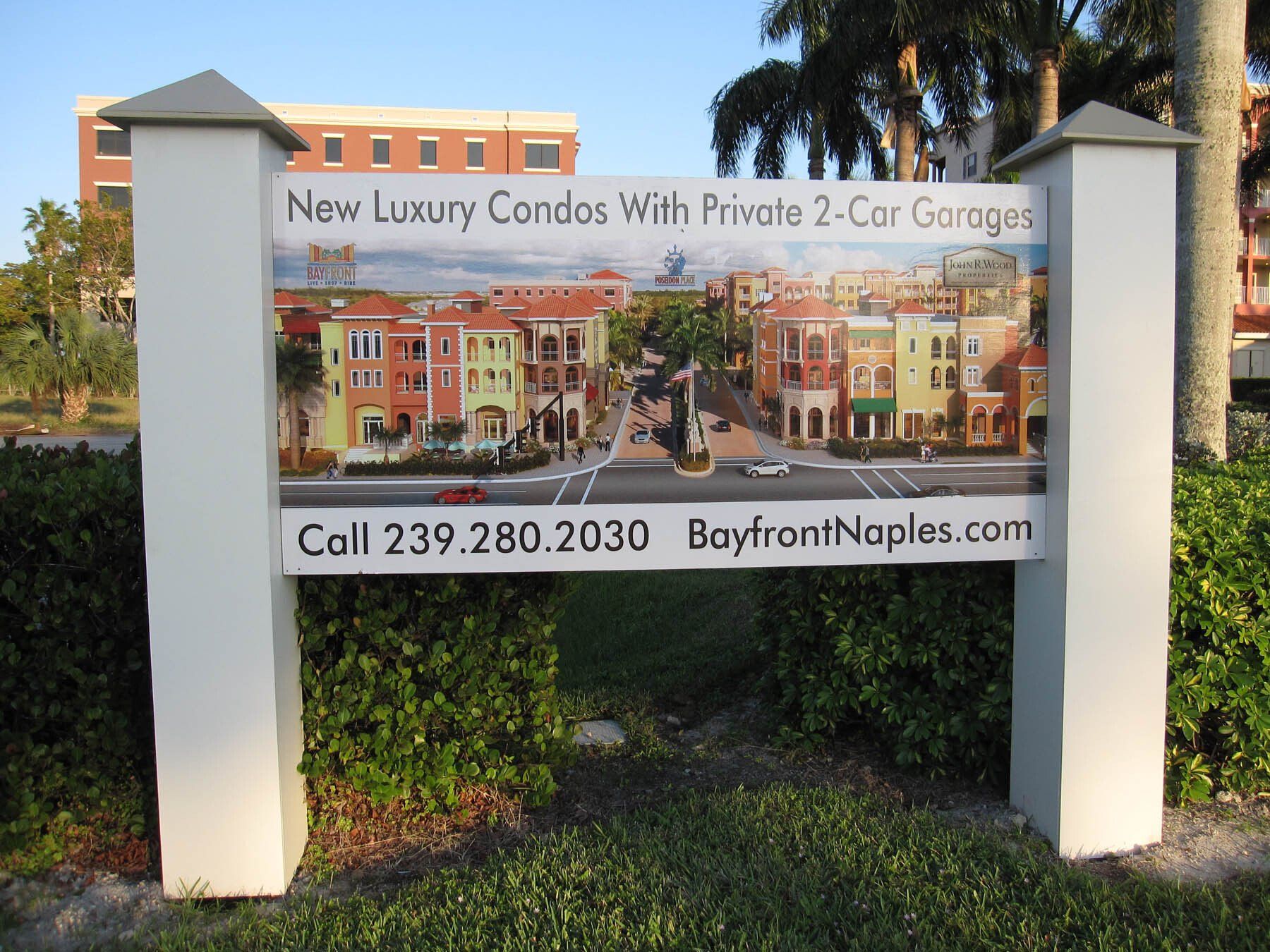 A sign for new luxury condos with private 2 car garages