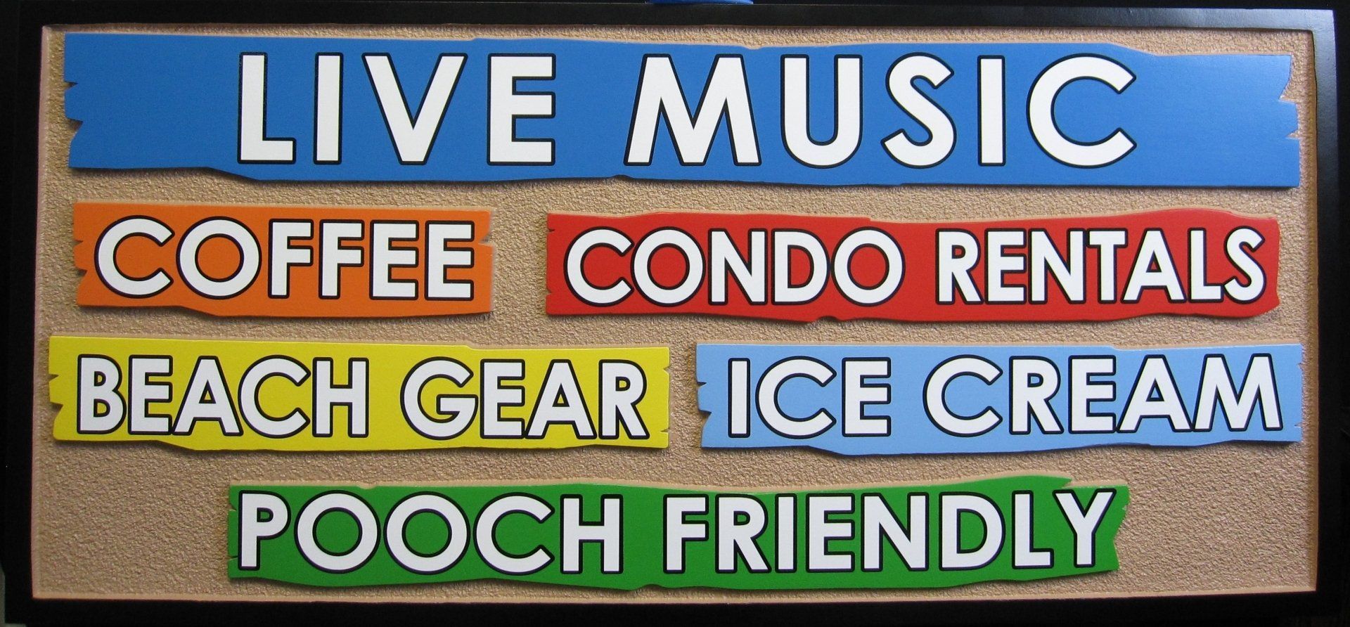 A sign that says live music coffee condo rentals beach gear ice cream pooch friendly