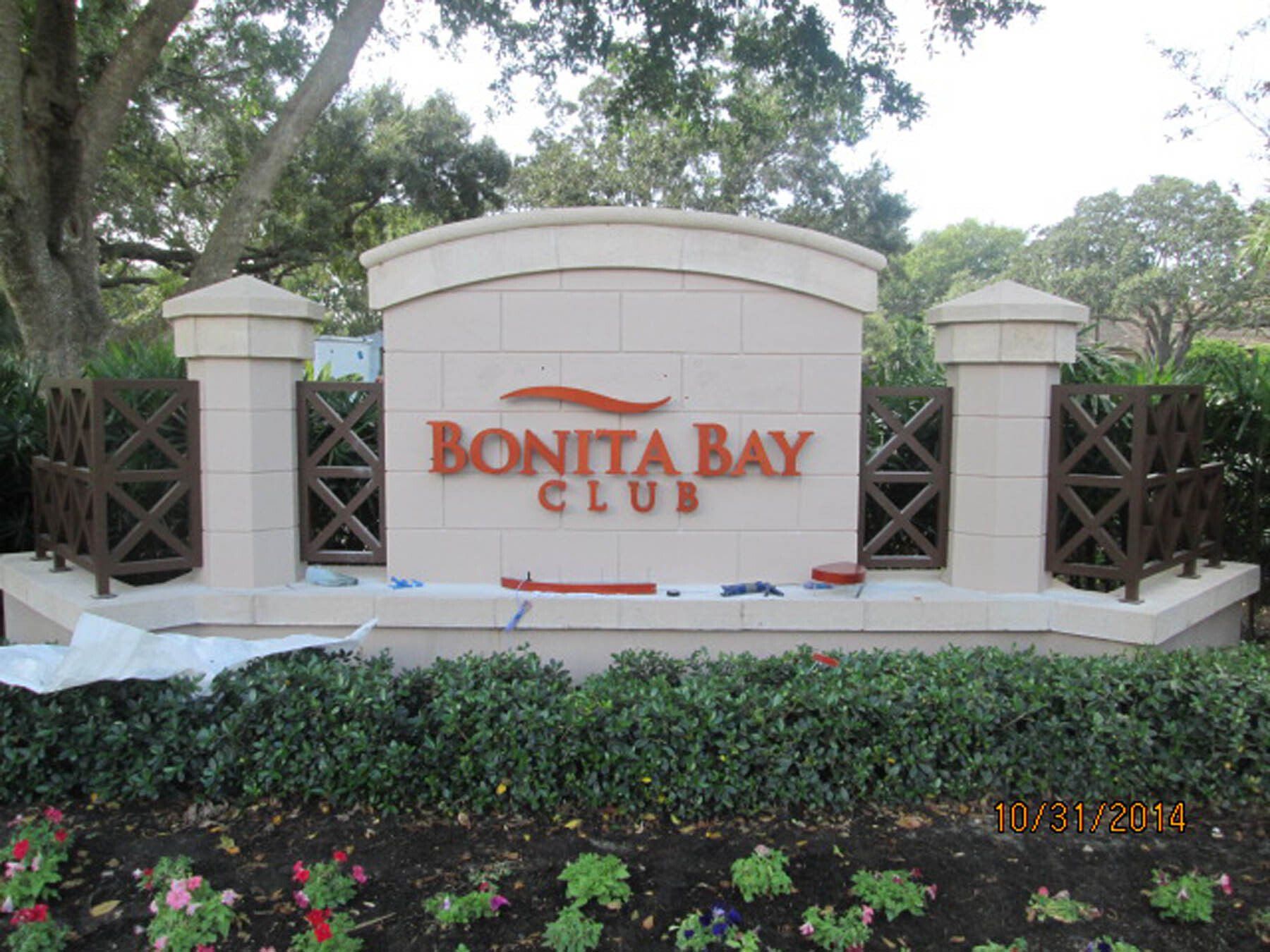 A sign for the bonita bay club is being painted