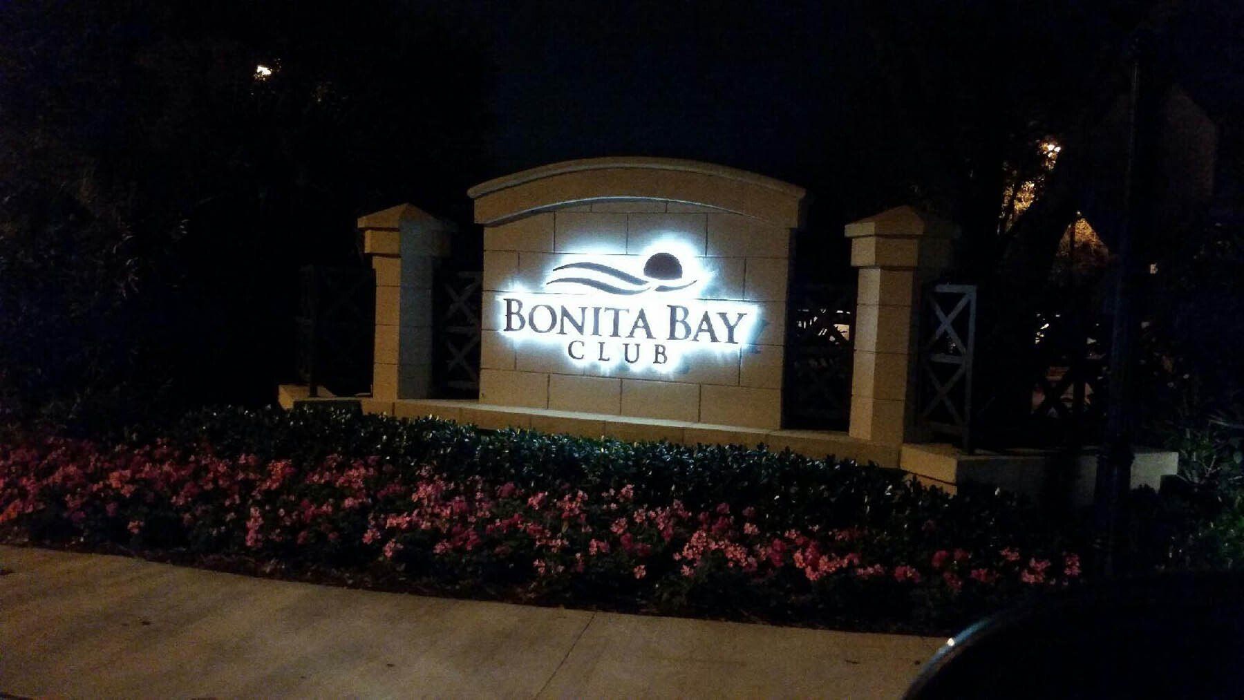 A sign for bonita bay is lit up at night