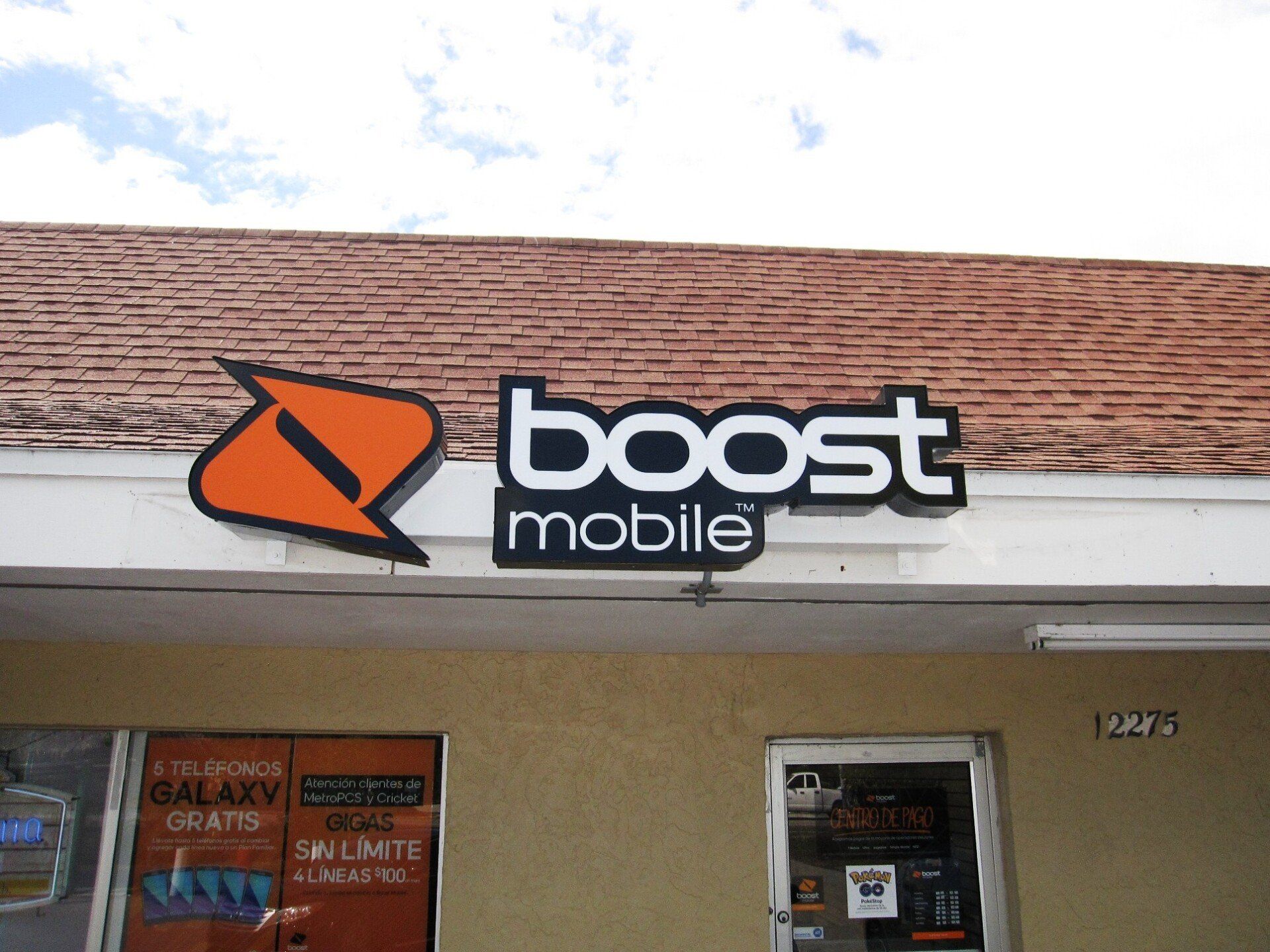 A boost mobile store front with a brick roof