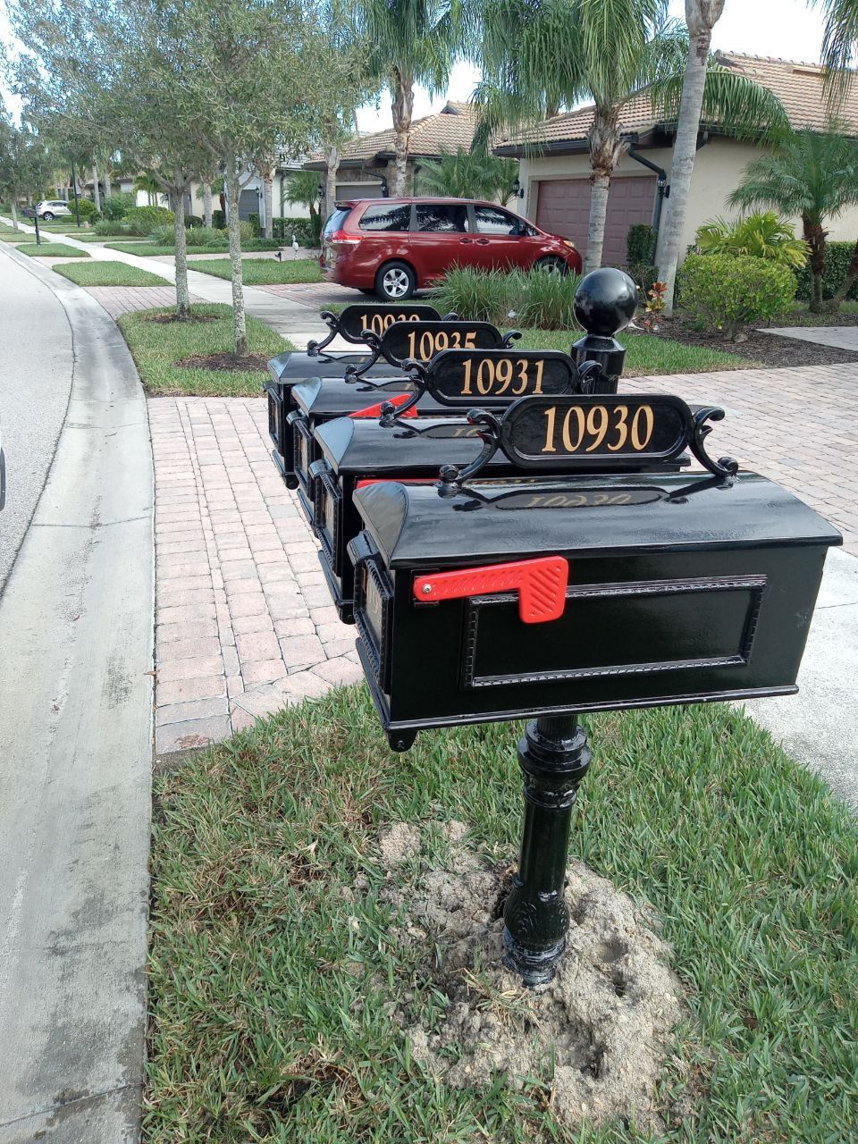 A row of black mailboxes with the numbers 10931 and 10930 on them