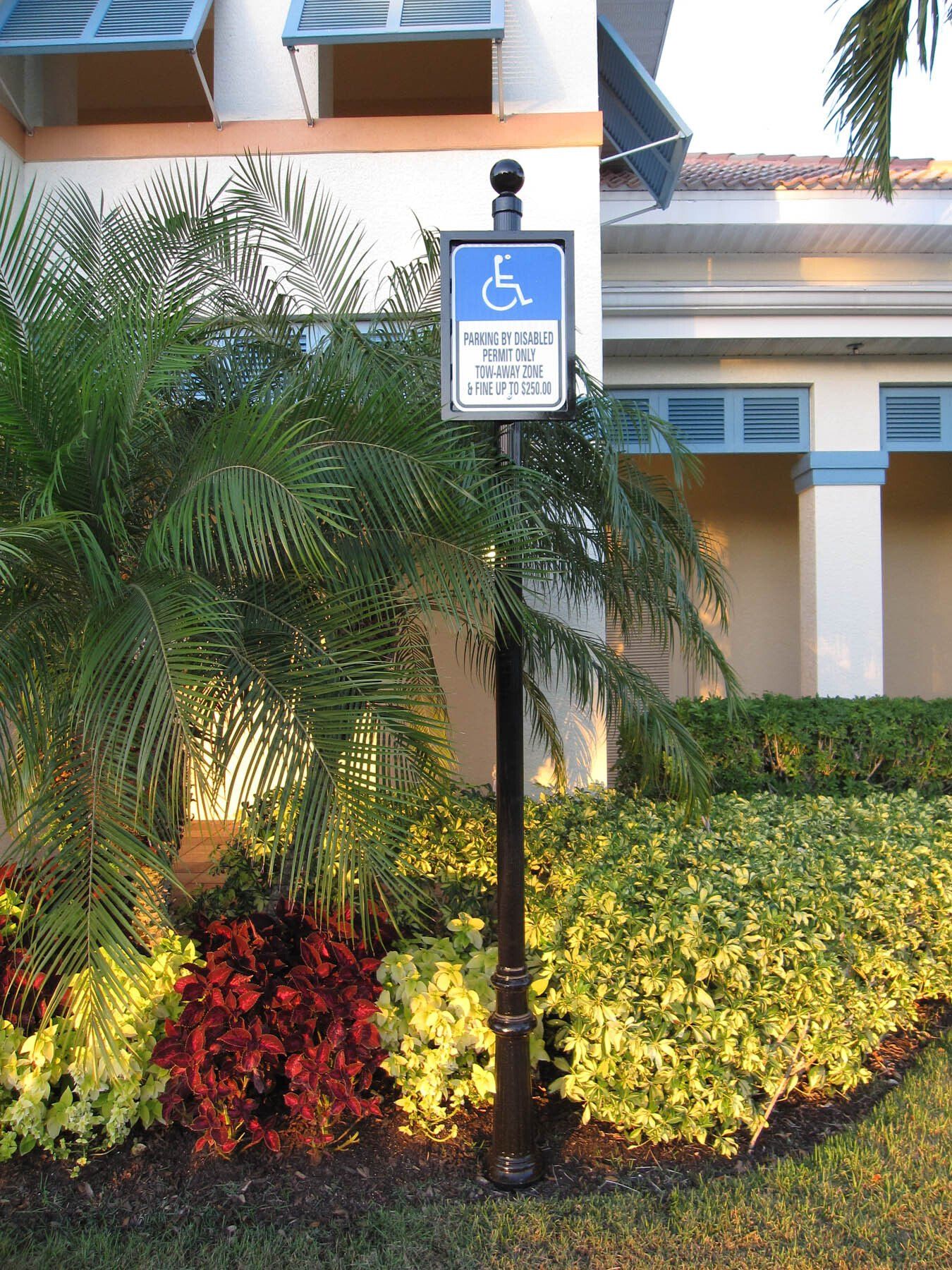 A handicapped parking sign in front of a building