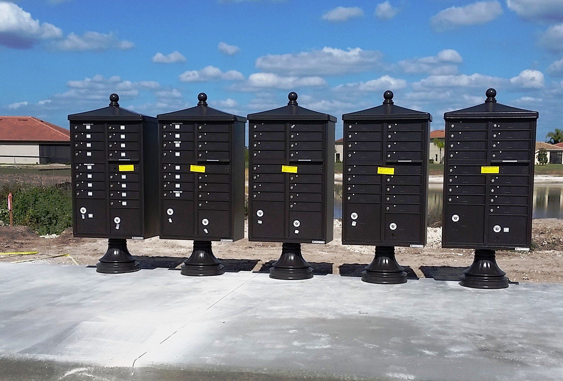A row of black mailboxes are lined up in a row