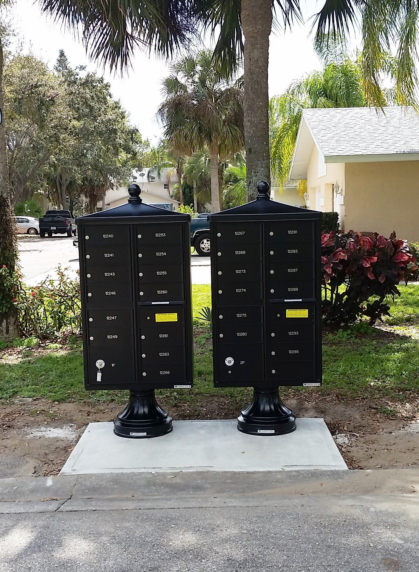 Two black mailboxes are sitting next to each other