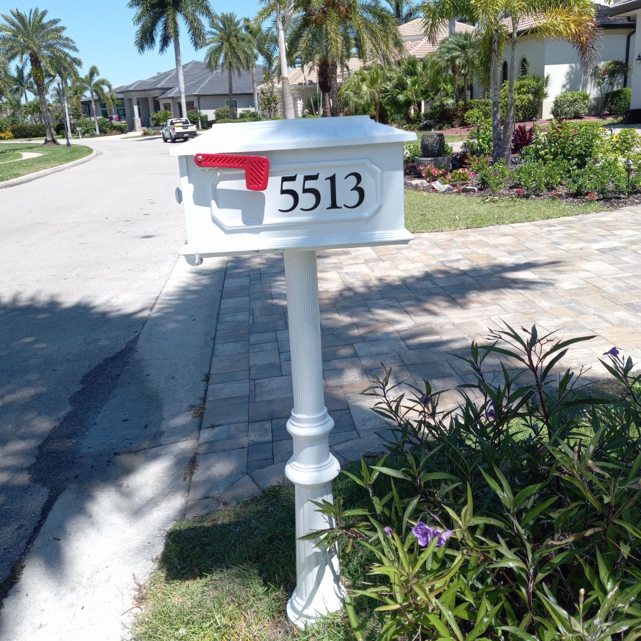 A white mailbox with the number 5513 on it