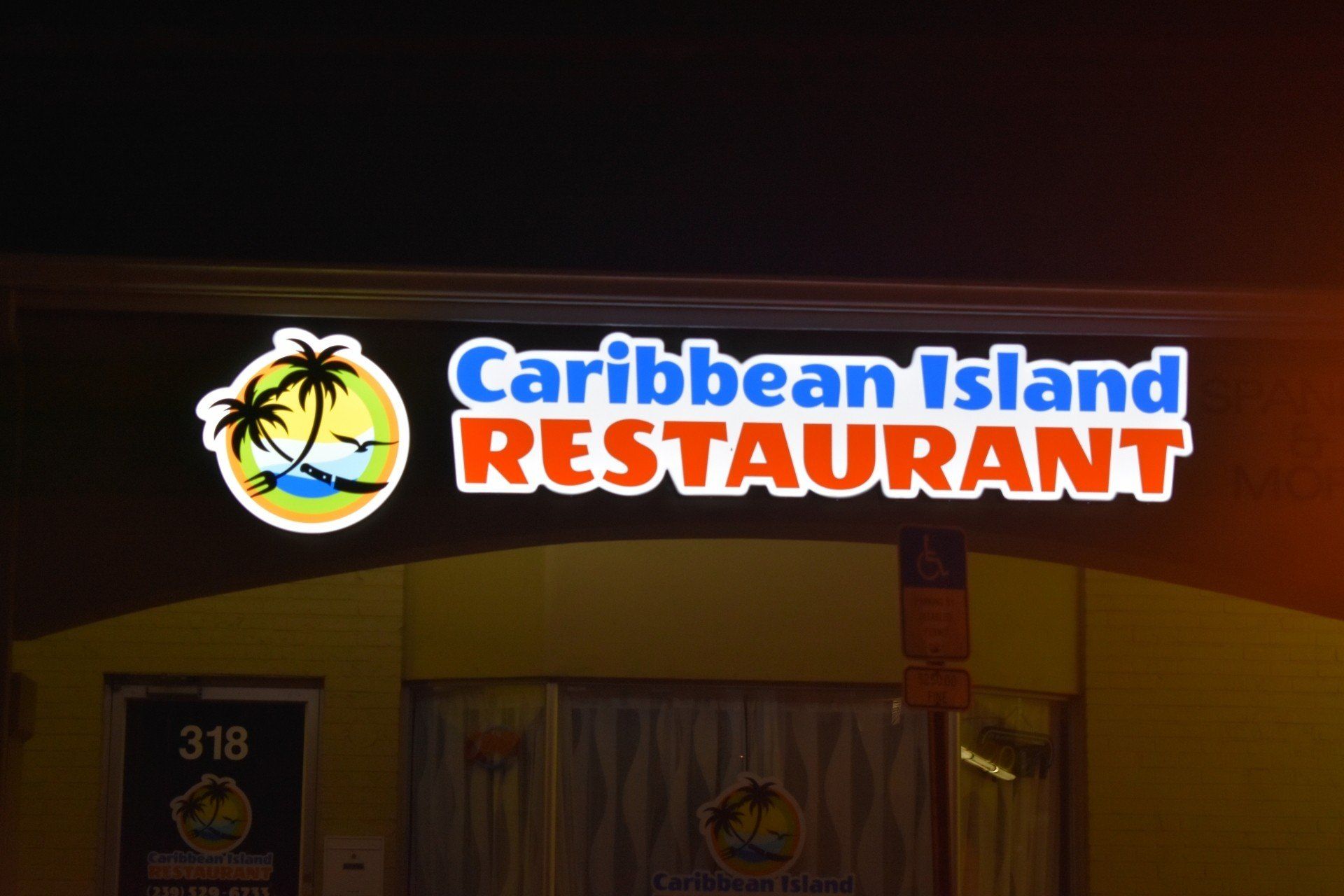 The caribbean island restaurant is lit up at night