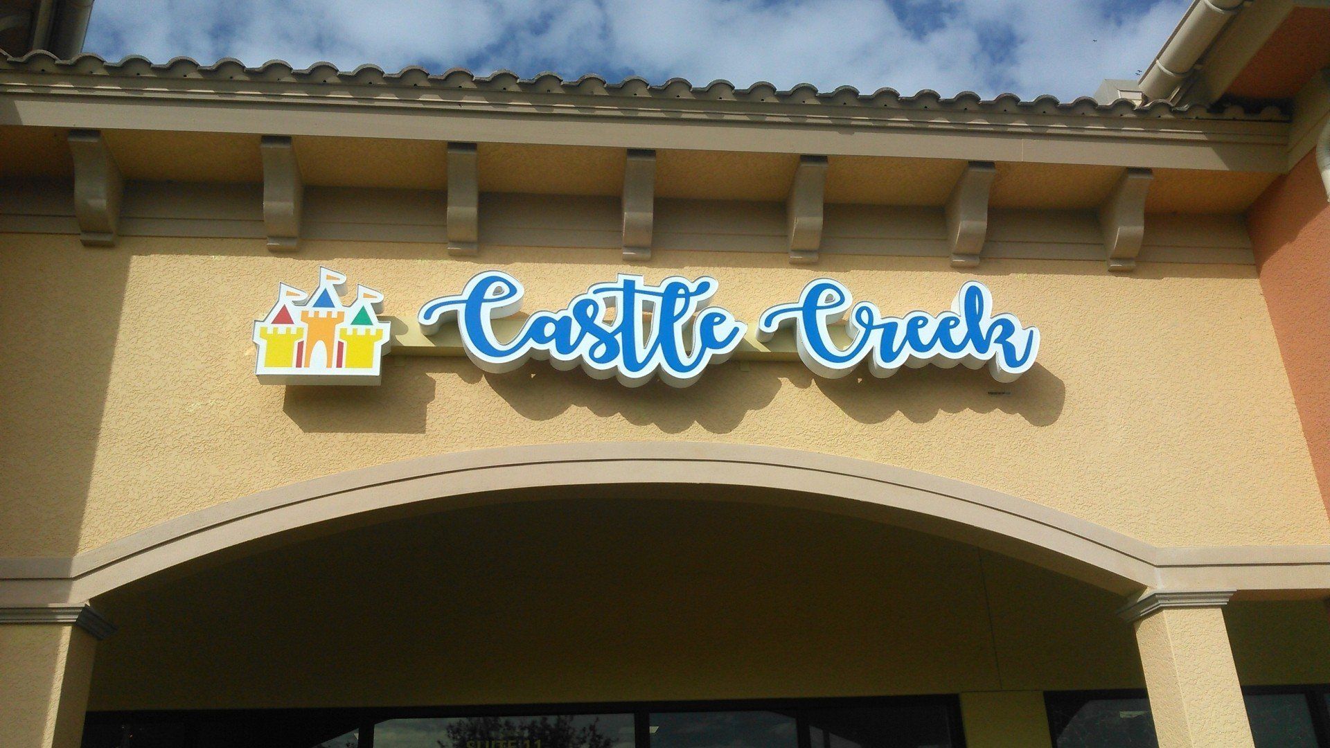 The front of a building with a sign that says castle creek
