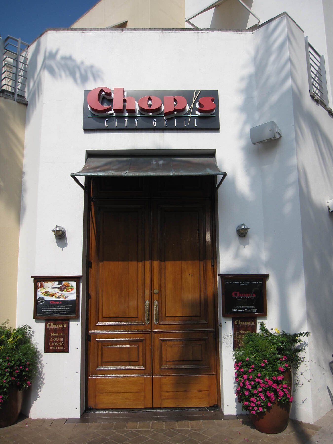 A white building with a sign that says chops on it