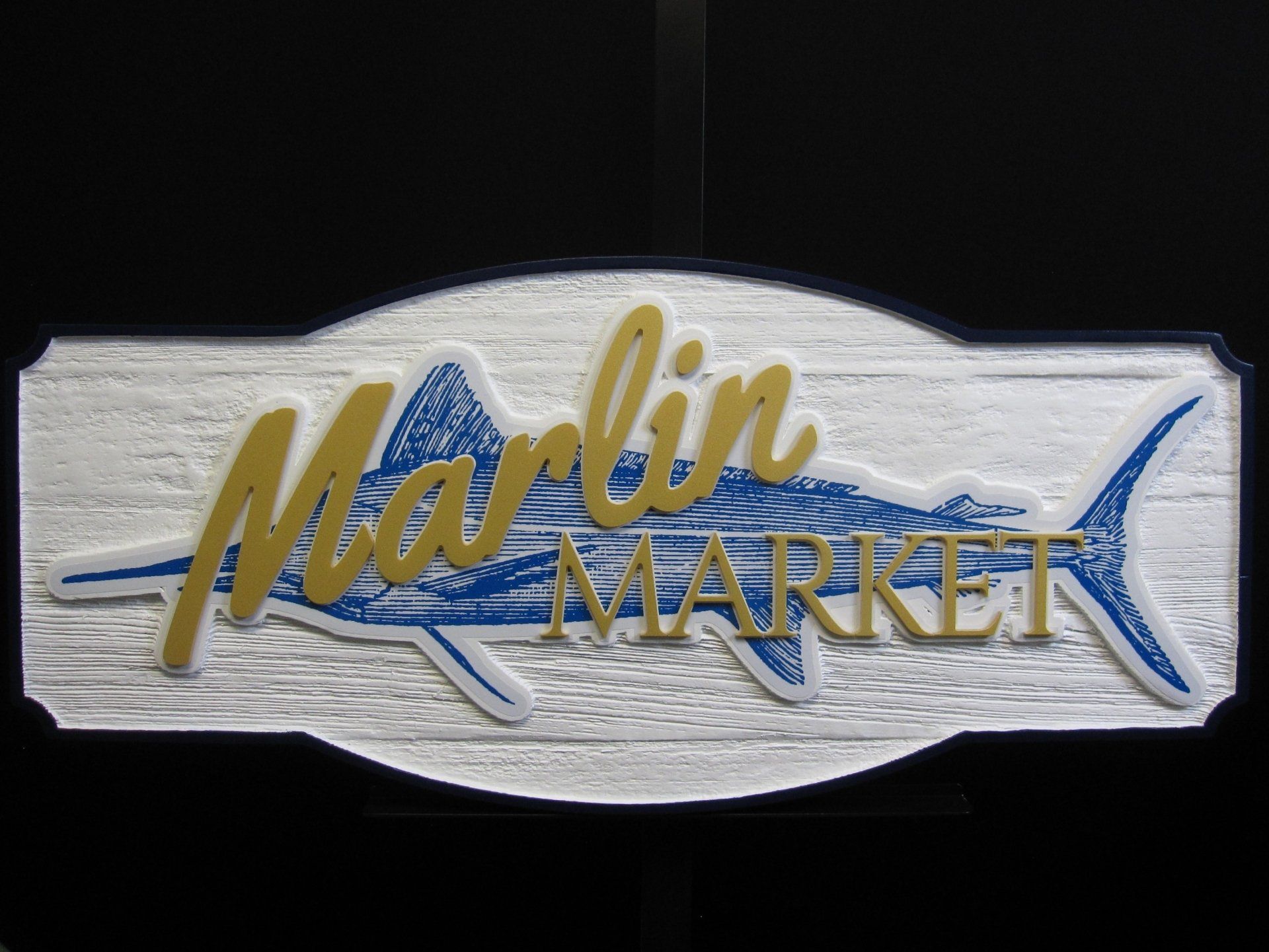 A sign for the marlin market with a fish on it