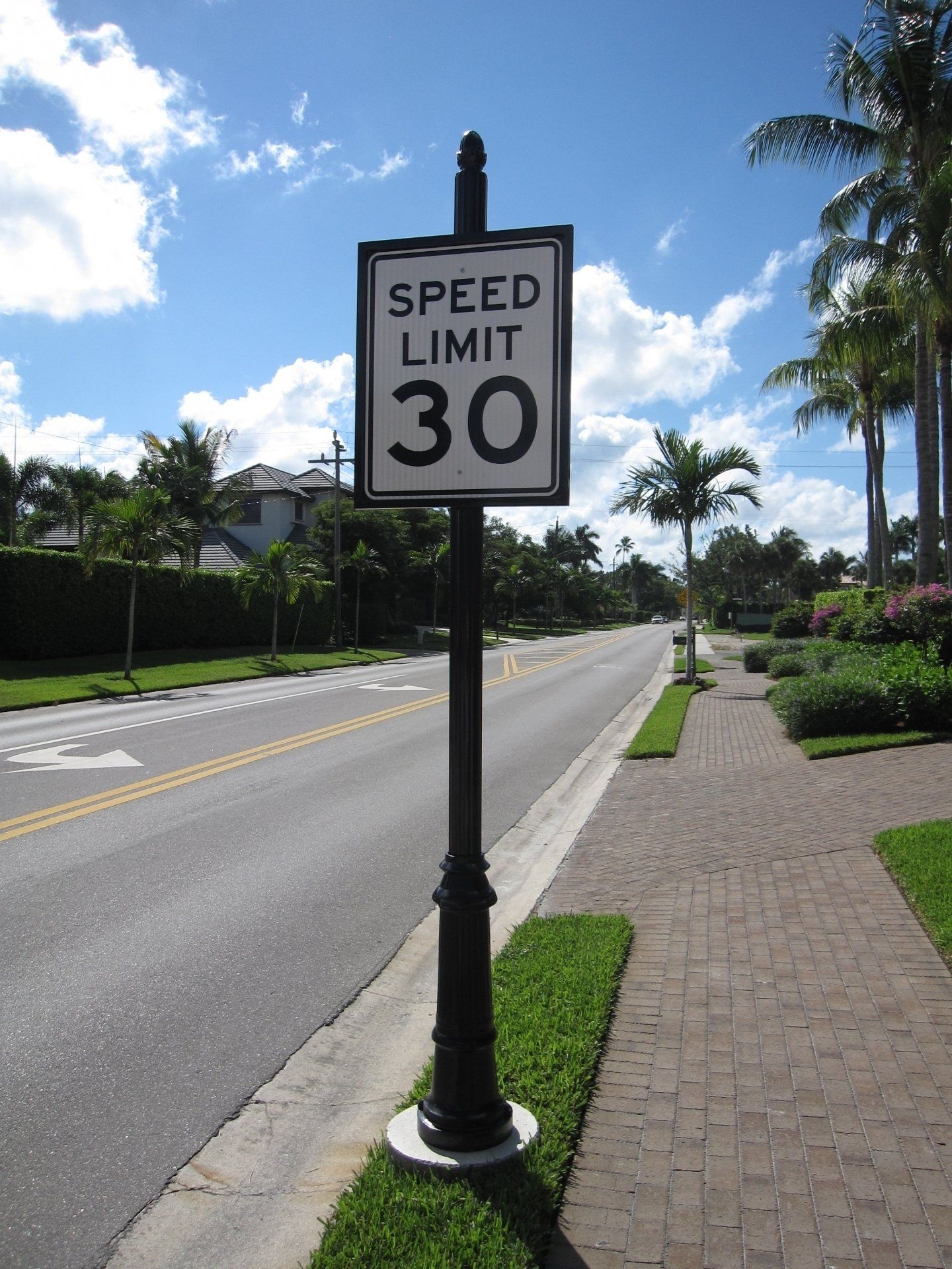 A speed limit sign on the side of a road