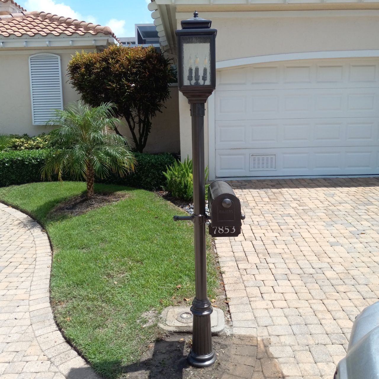 A mailbox in front of a house with the number 414 on it