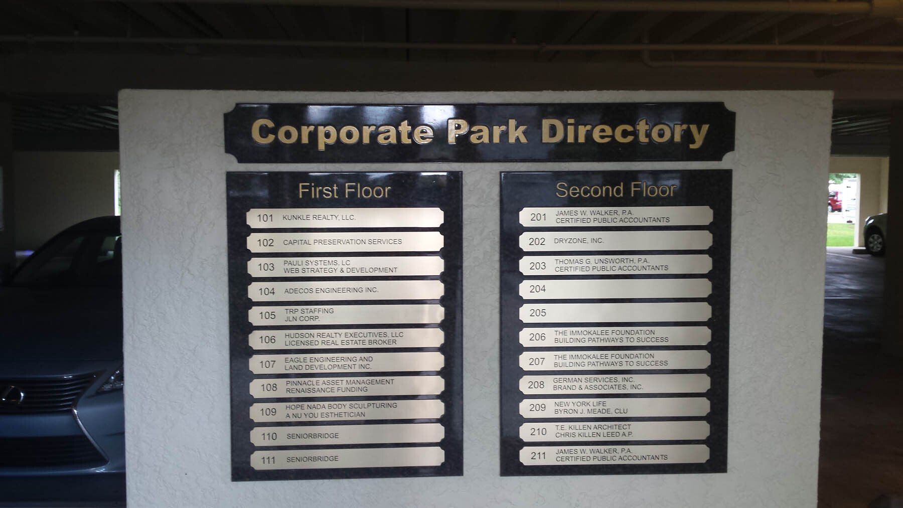 A corporate park directory in a parking garage