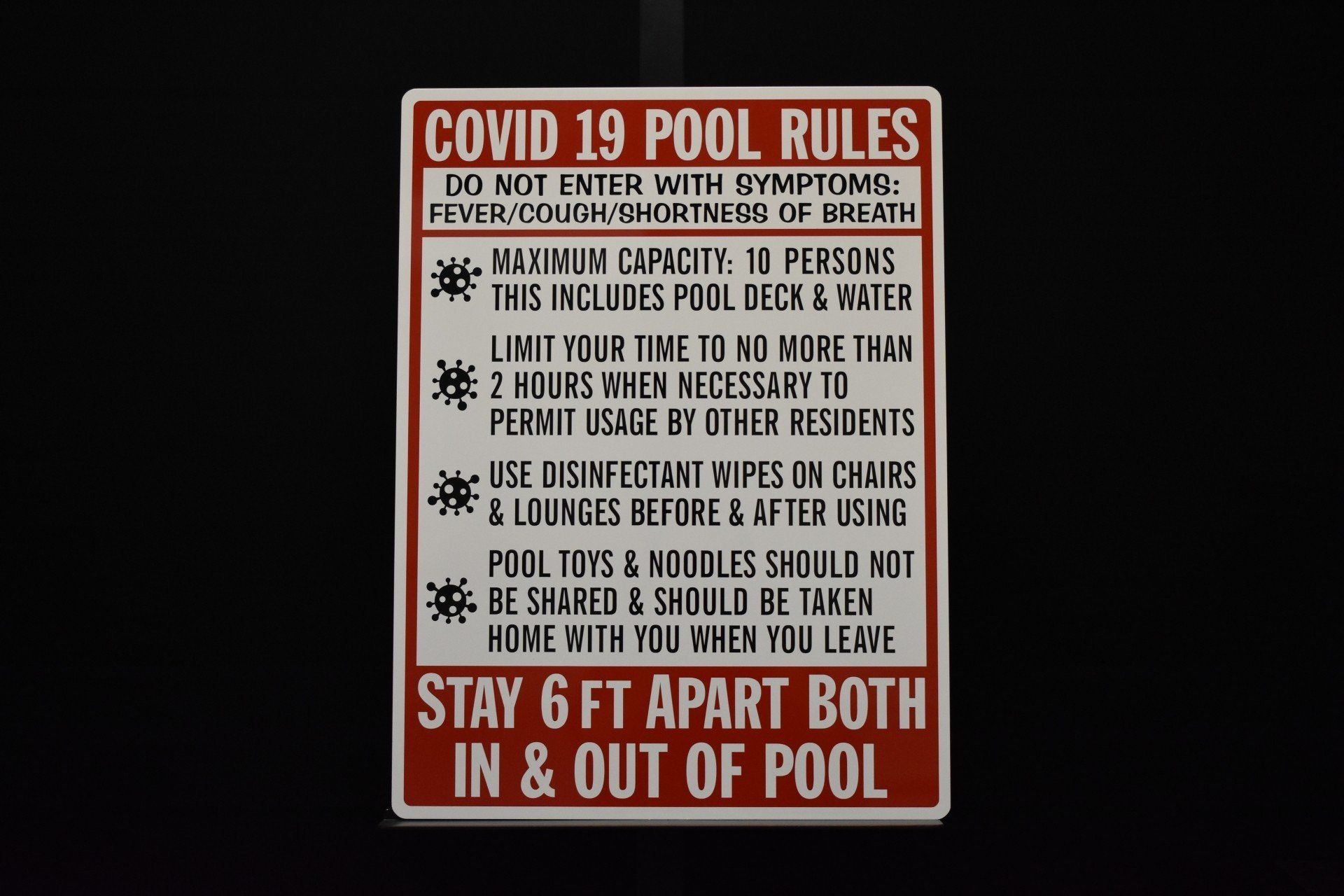 A sign that says covid 19 pool rules on it