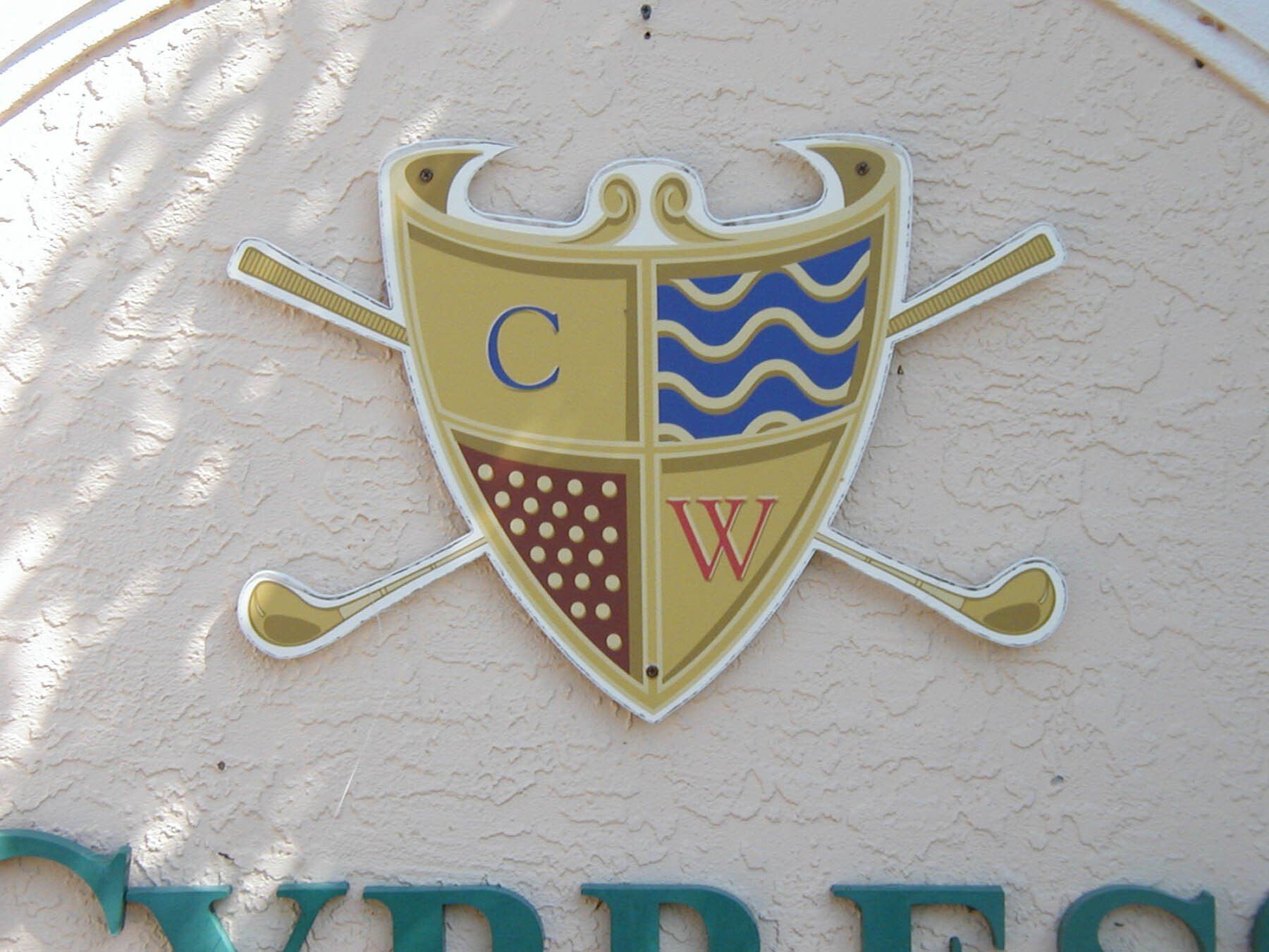 A shield with the letter c and w on it