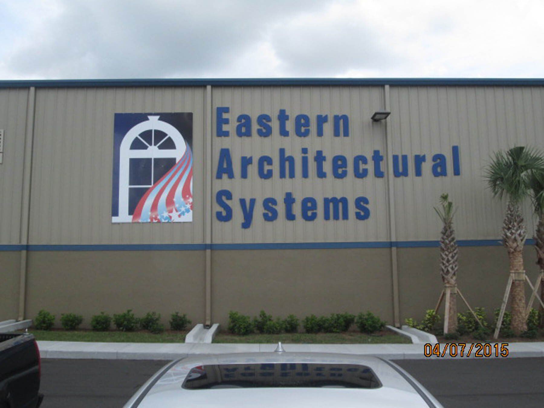 A sign on the side of a building that says eastern architectural systems