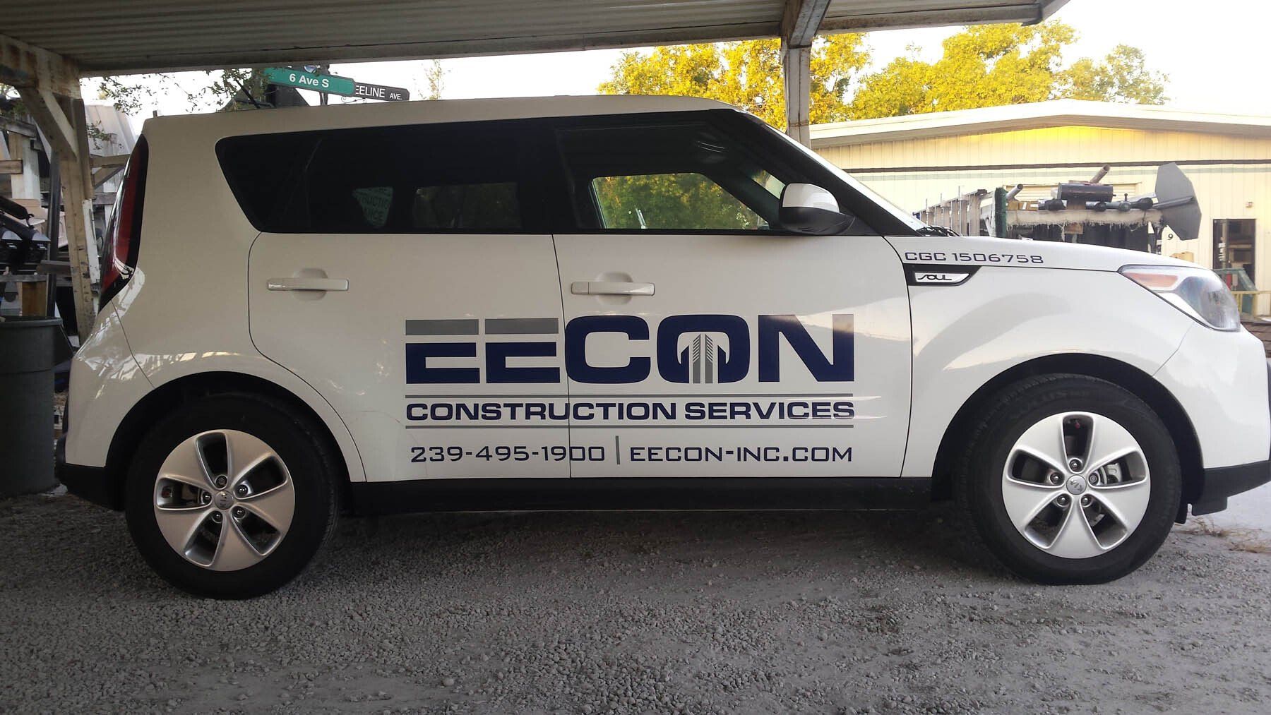A white car with eecon construction services written on the side