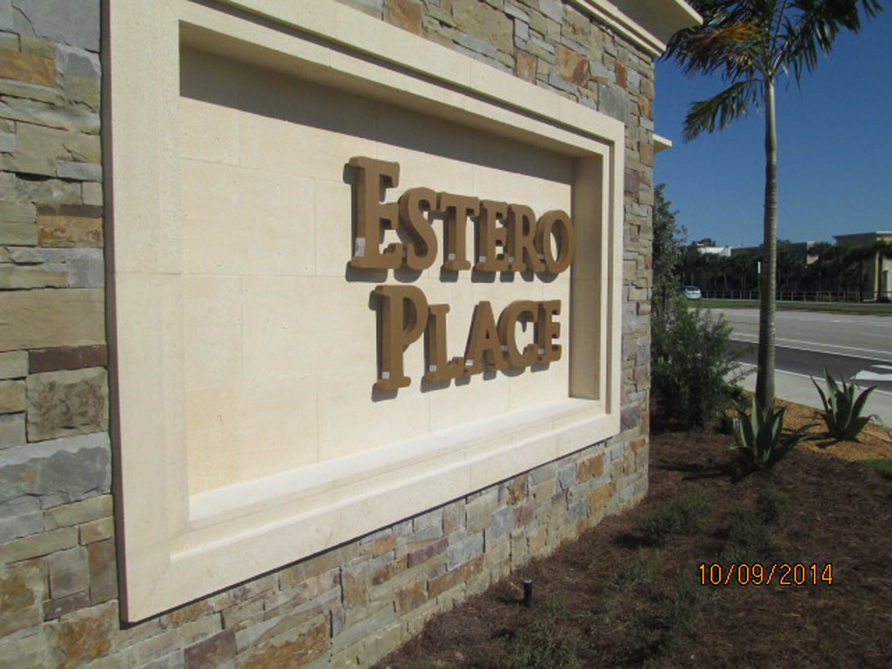 A stone wall with a sign that says estero place