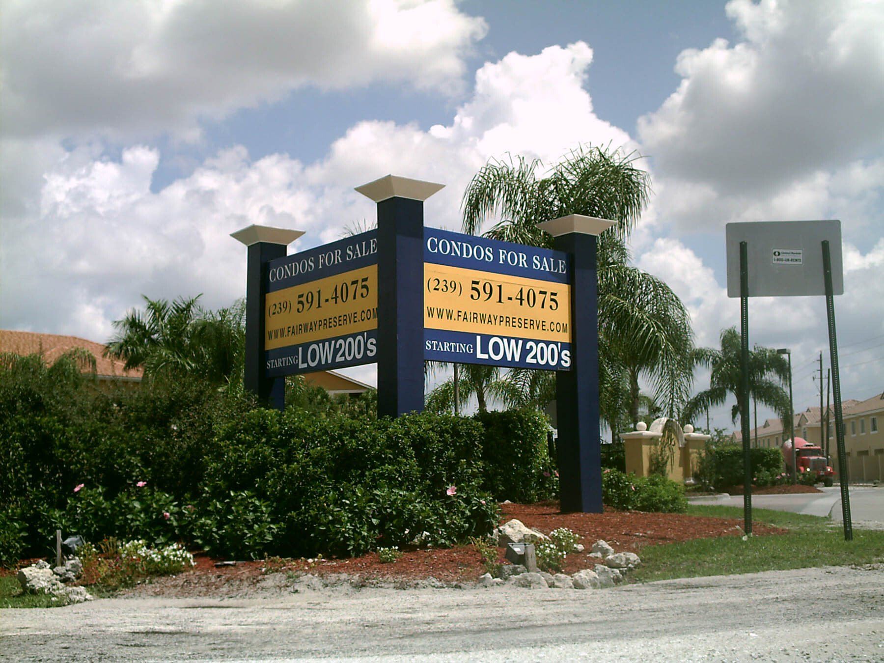 A blue and yellow sign that says low prices on it