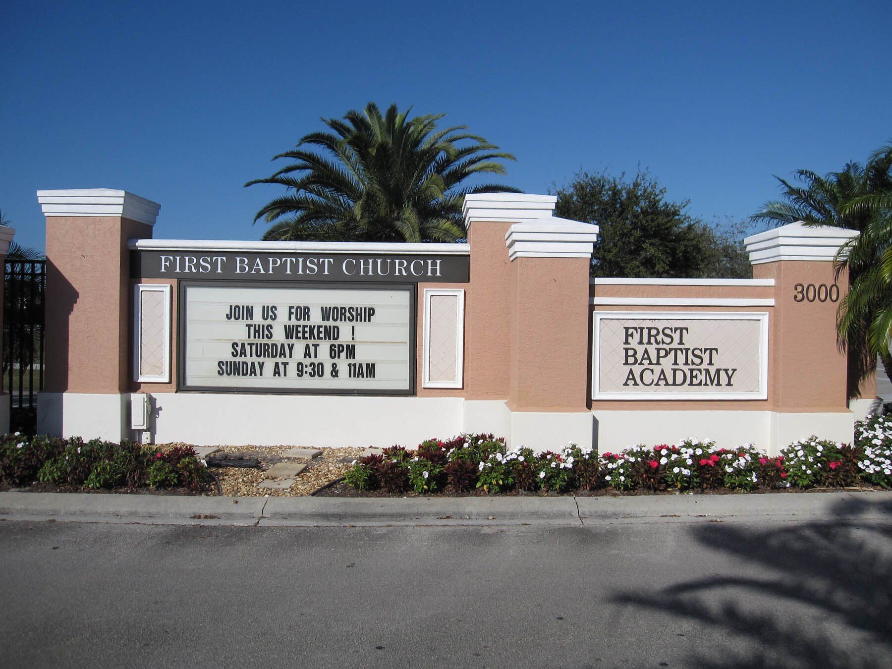 A sign for the first baptist church and first baptist academy